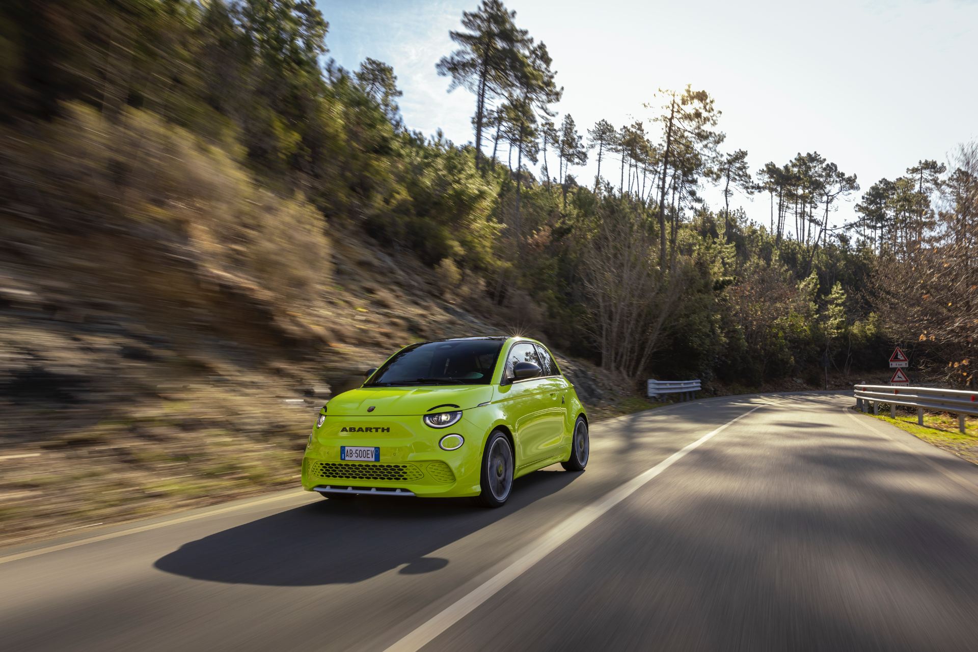 2024 abarth 500e driving front hillside road green