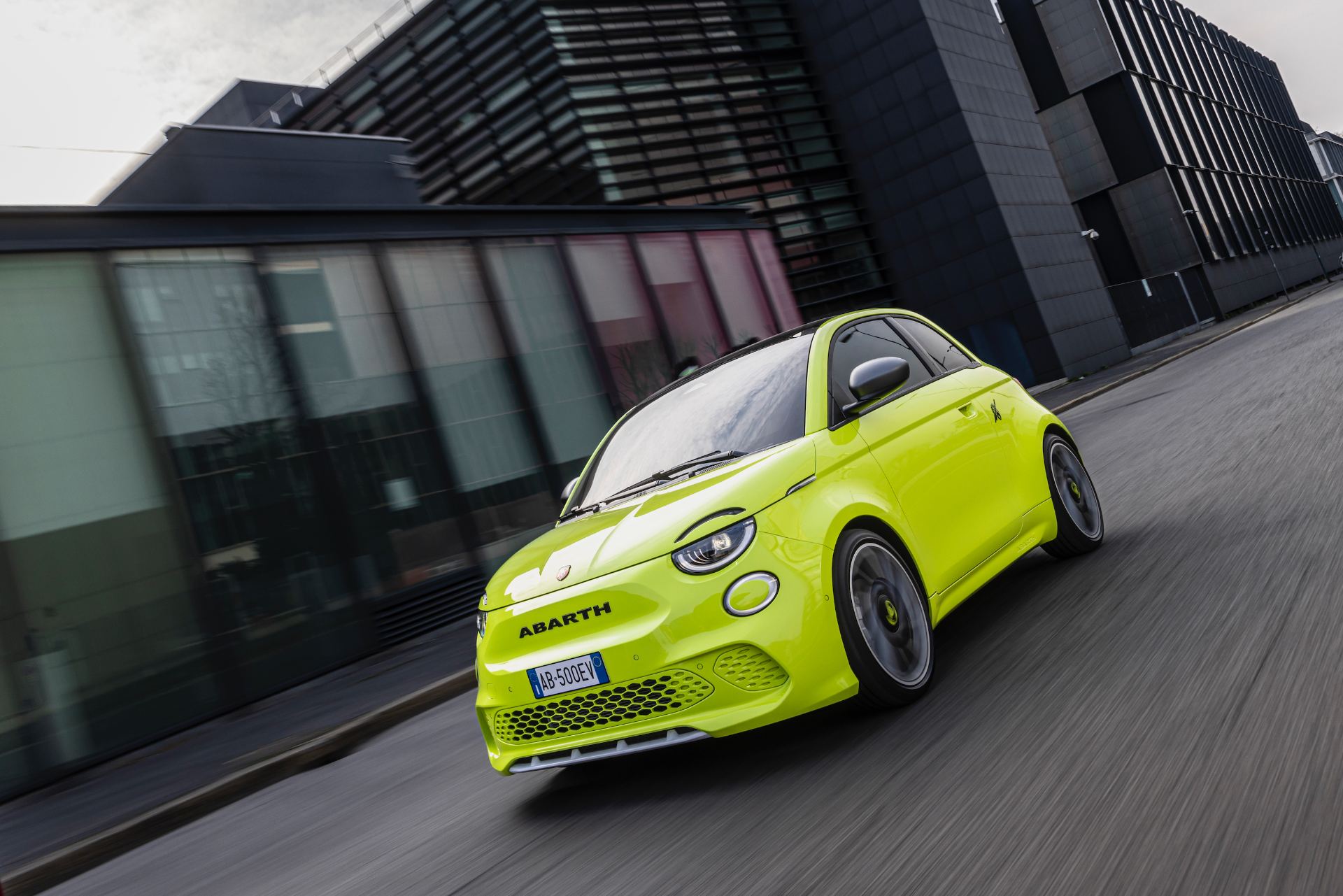 2024 abarth 500e driving front three quarter city green