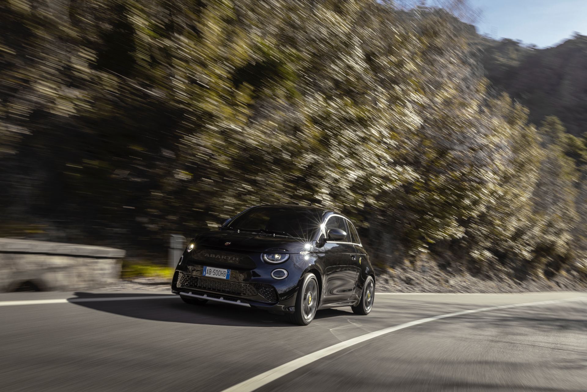 2024 abarth 500e driving front three quarter black