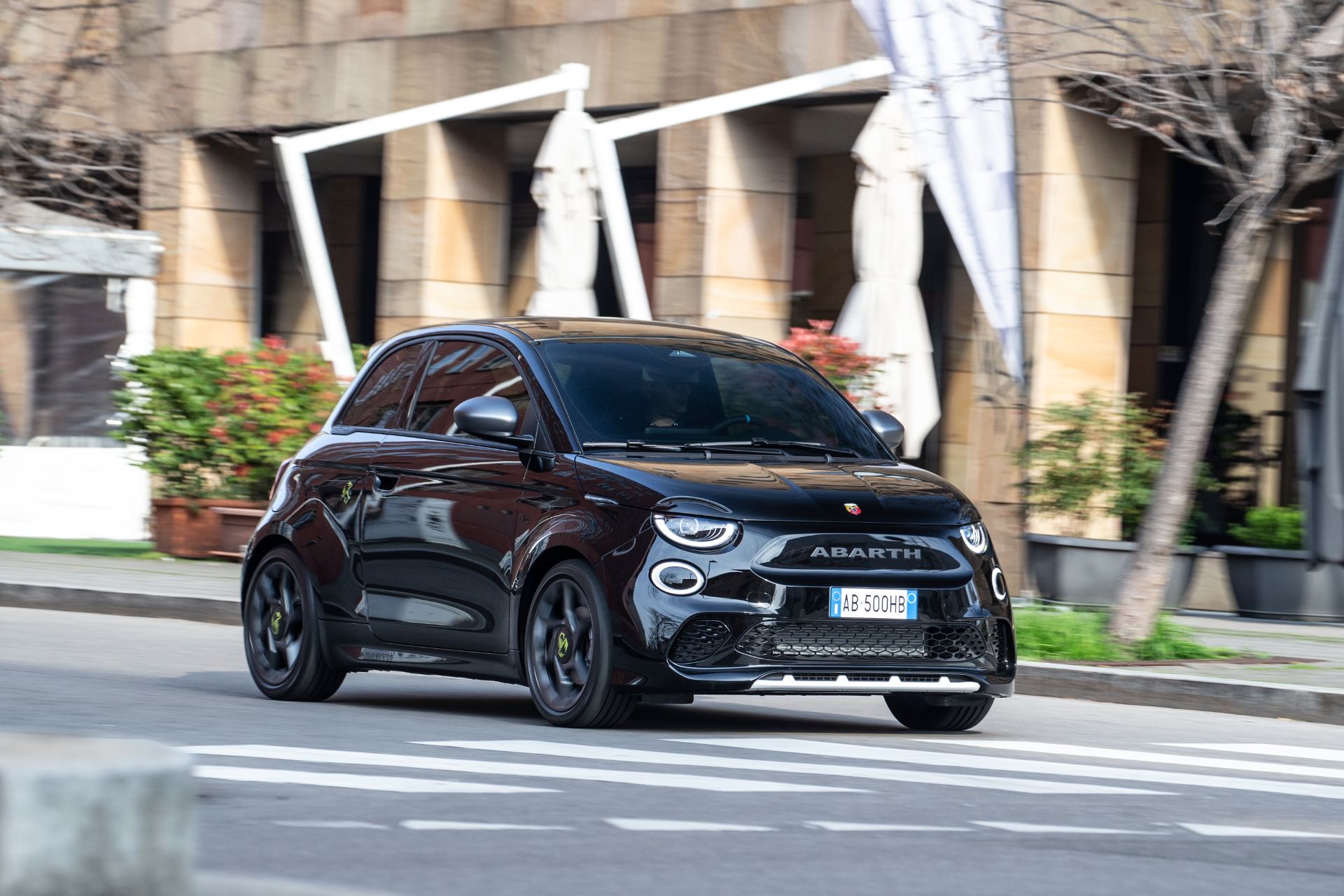 2024 abarth 500e driving front three quarter street black