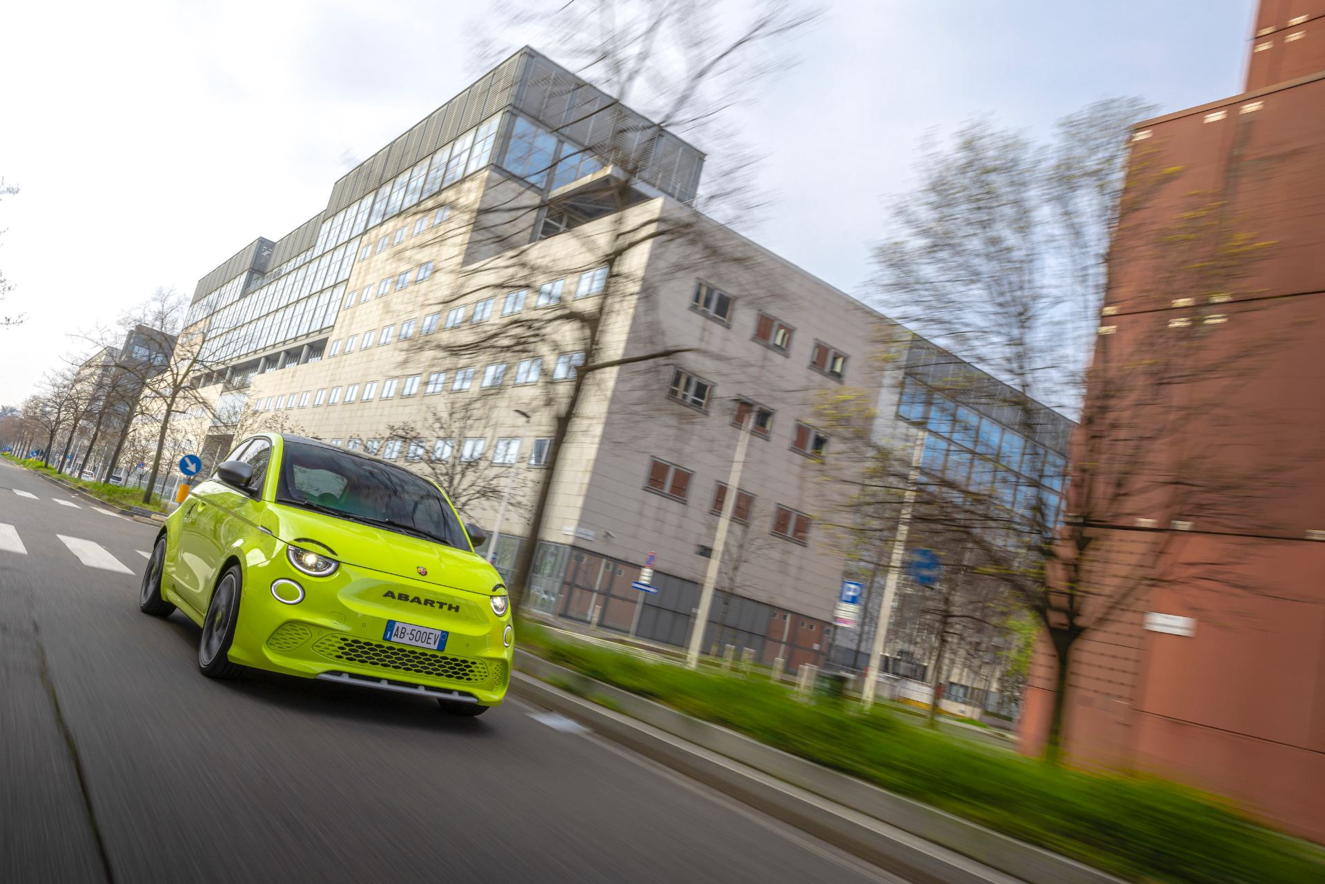 2024 abarth 500e driving front three quarter avenue green