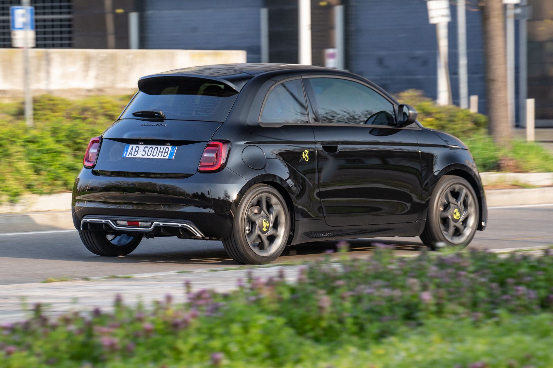 2024 abarth 500e driving rear three quarter black