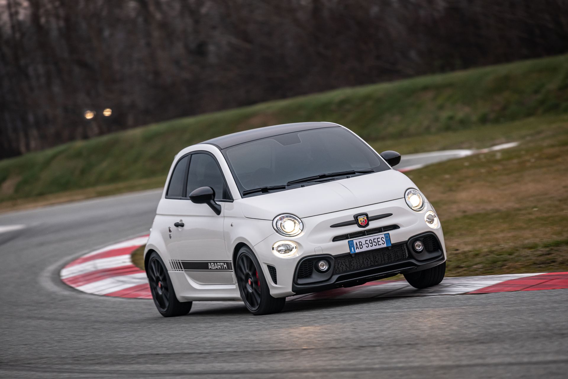2021 abarth 595 driving front three quarter track white