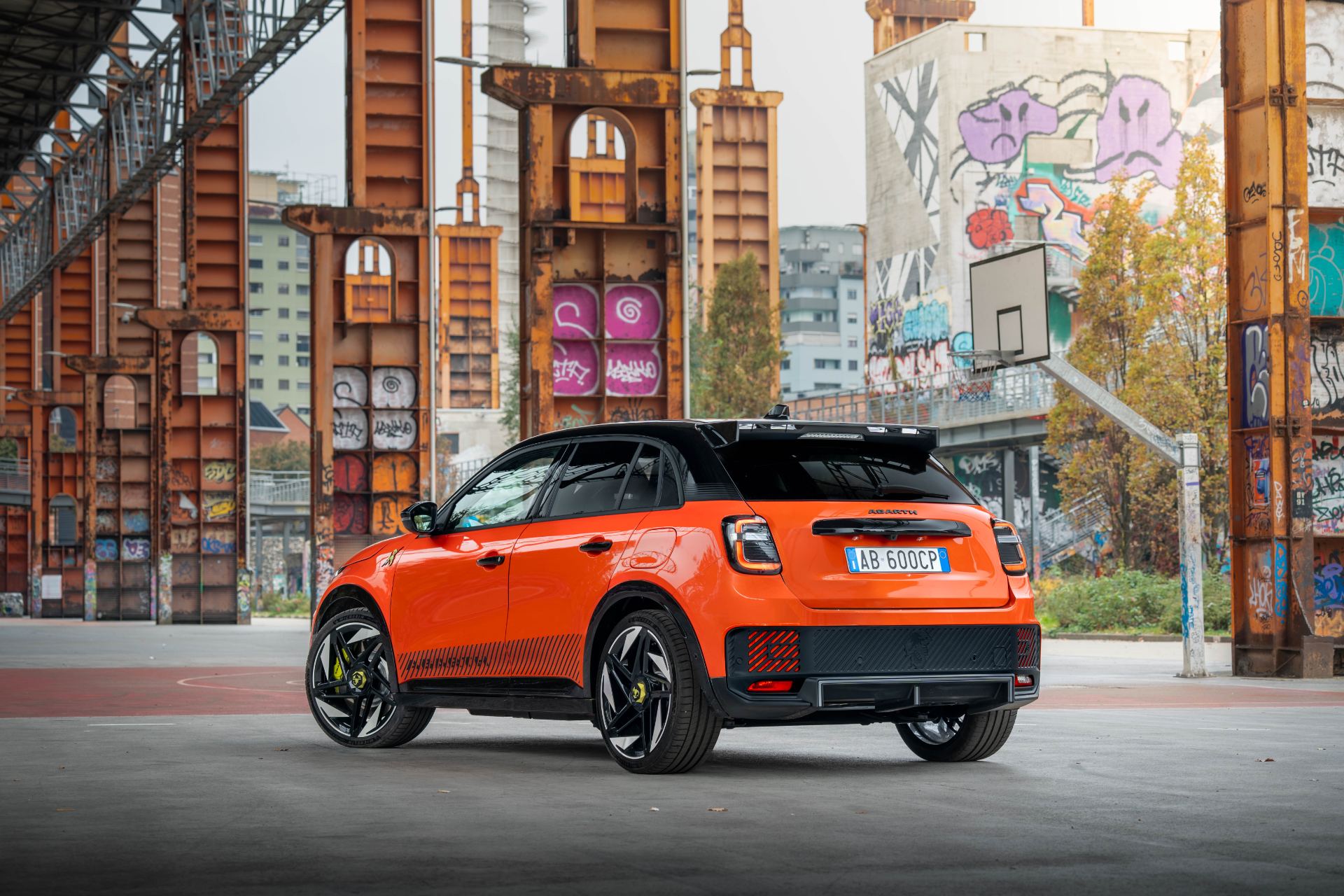 2025 abarth 600e rear three quarter orange