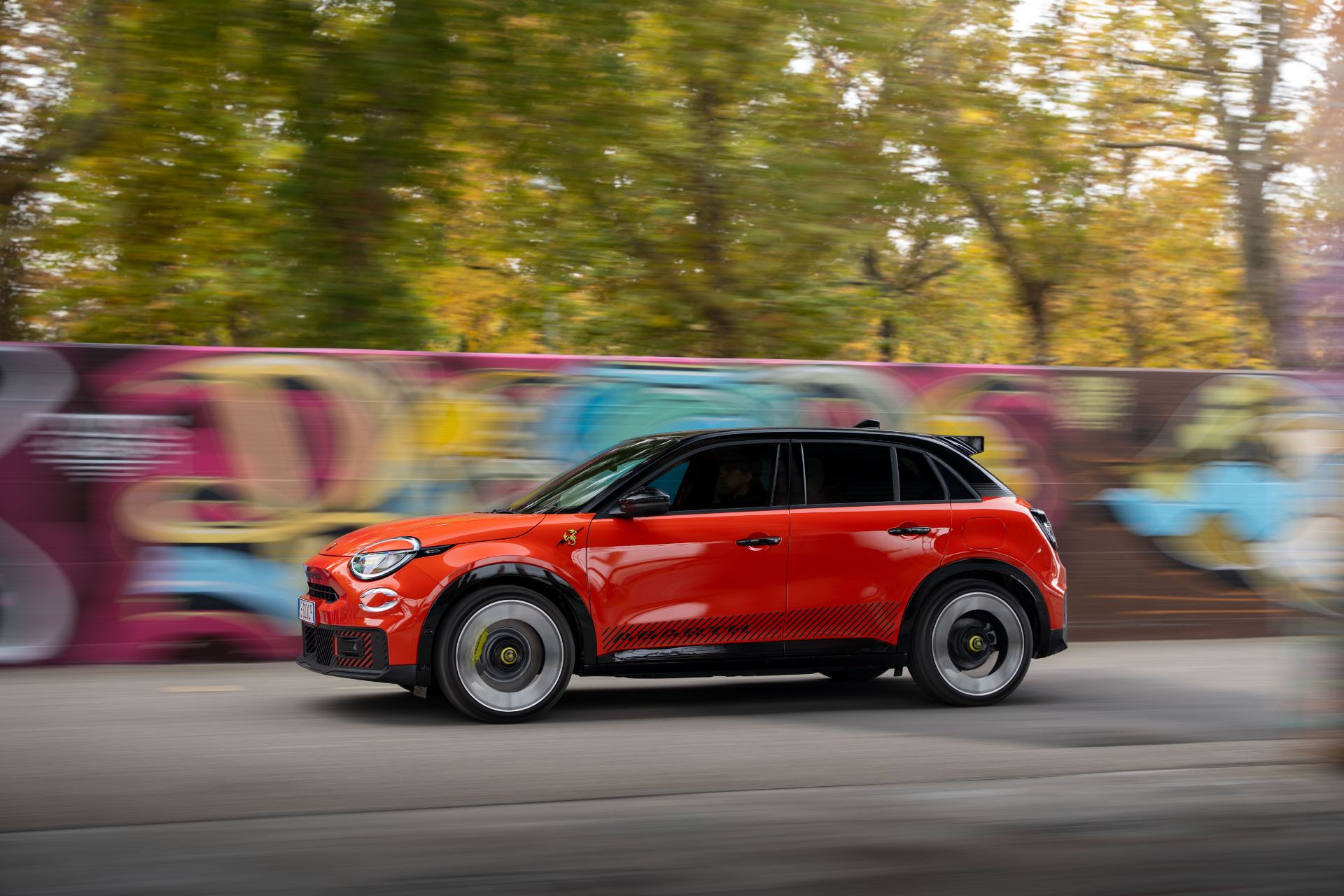 2025 abarth 600e driving side profile orange