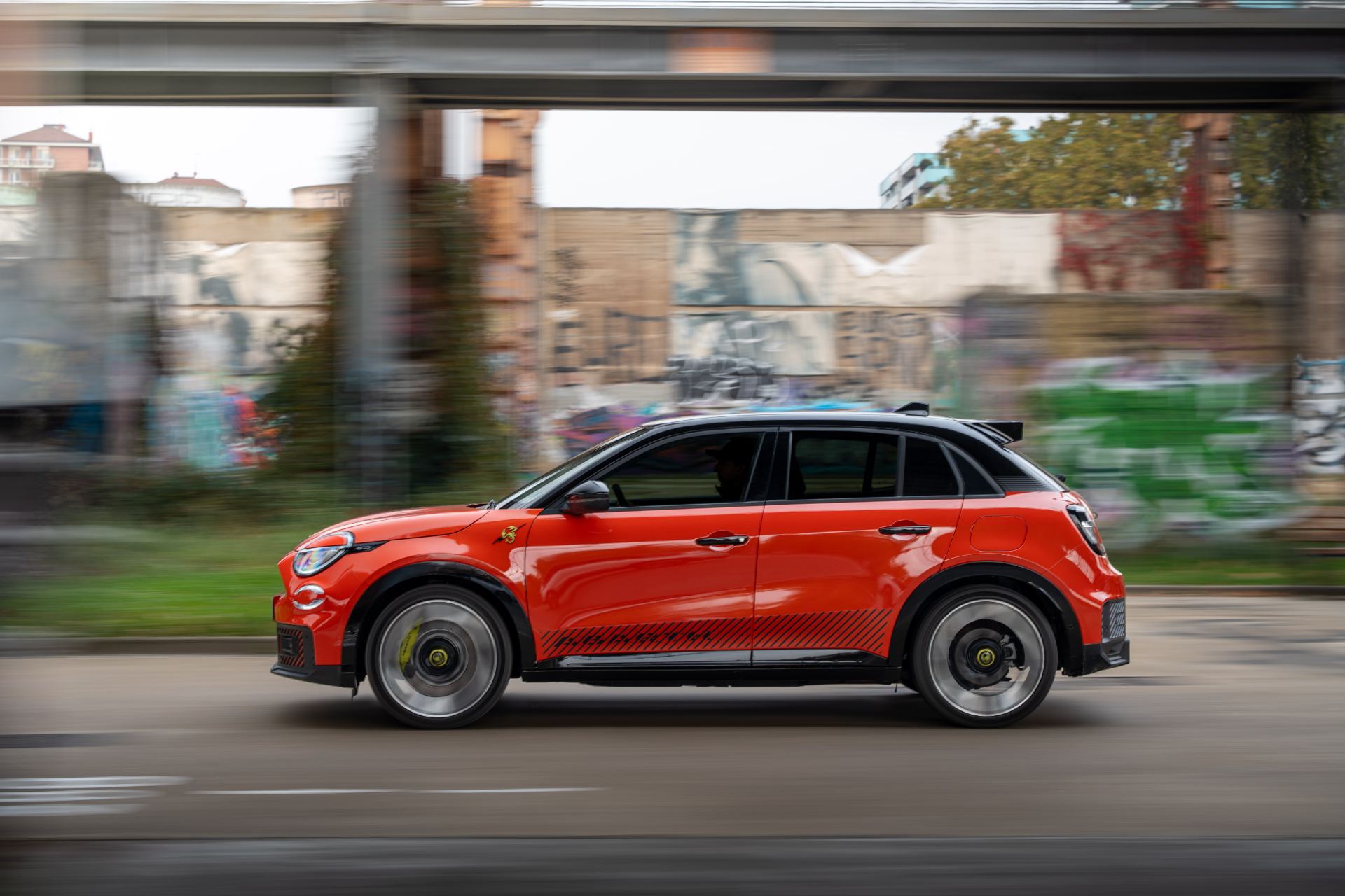 2025 abarth 600e driving side profile industrial orange