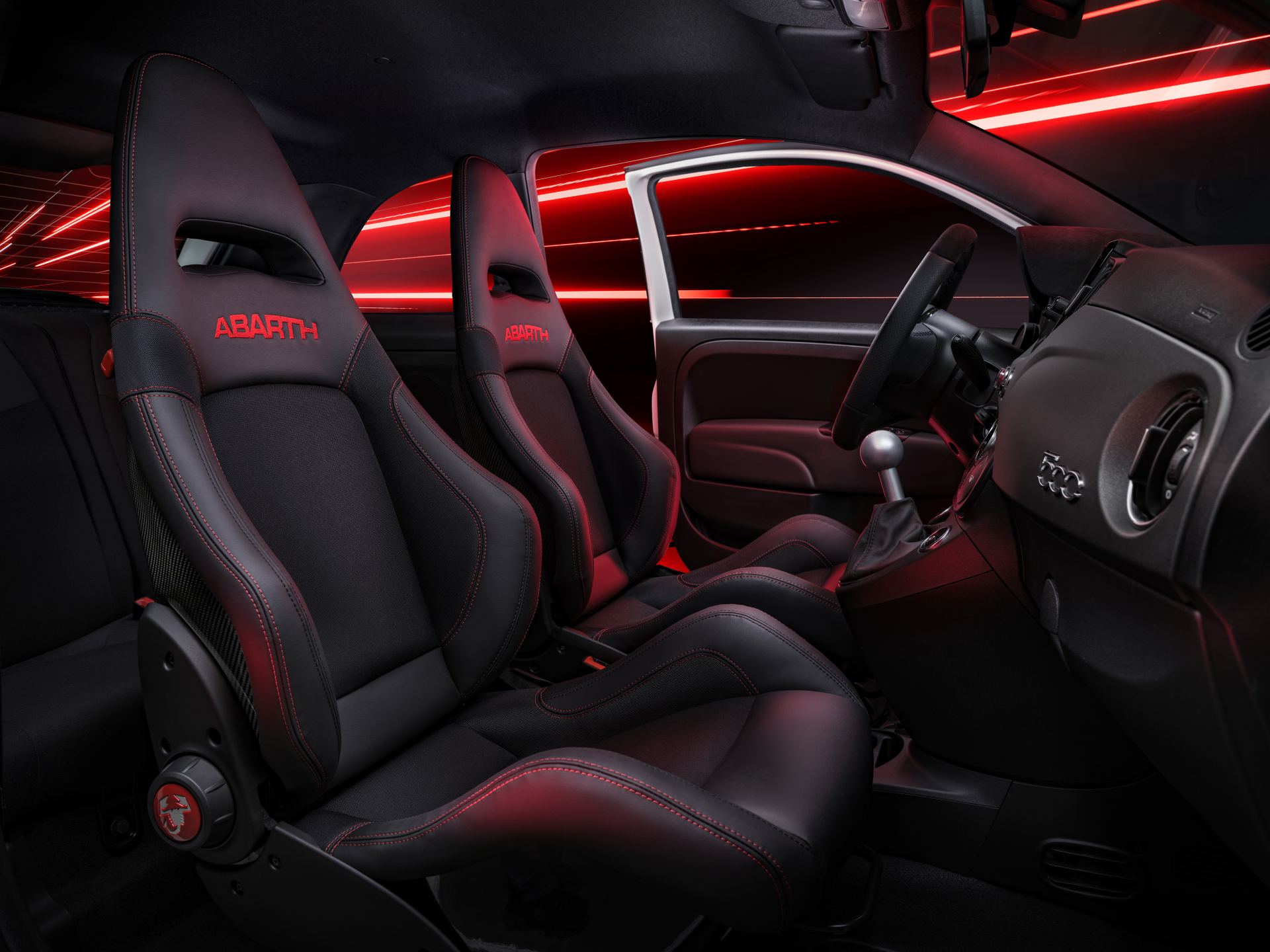 2024 abarth 695 interior front sport seats red lighting
