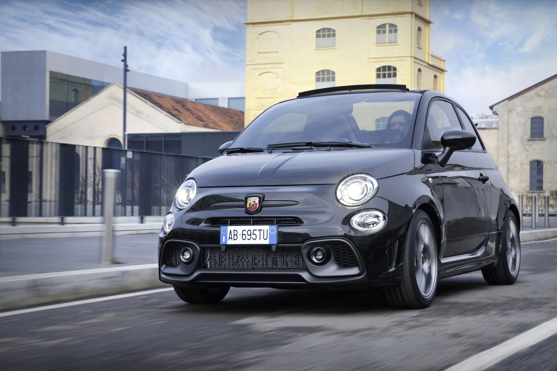 2024 abarth 695 driving front three quarter convertible black