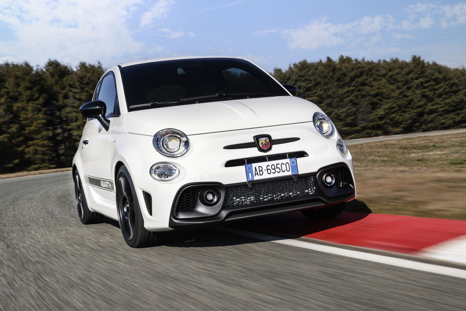 2024 abarth 695 driving front three quarter track white