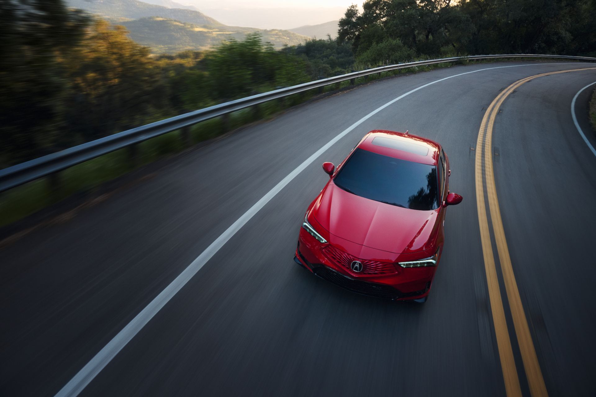 2026 acura integra a spec driving front hillside road red