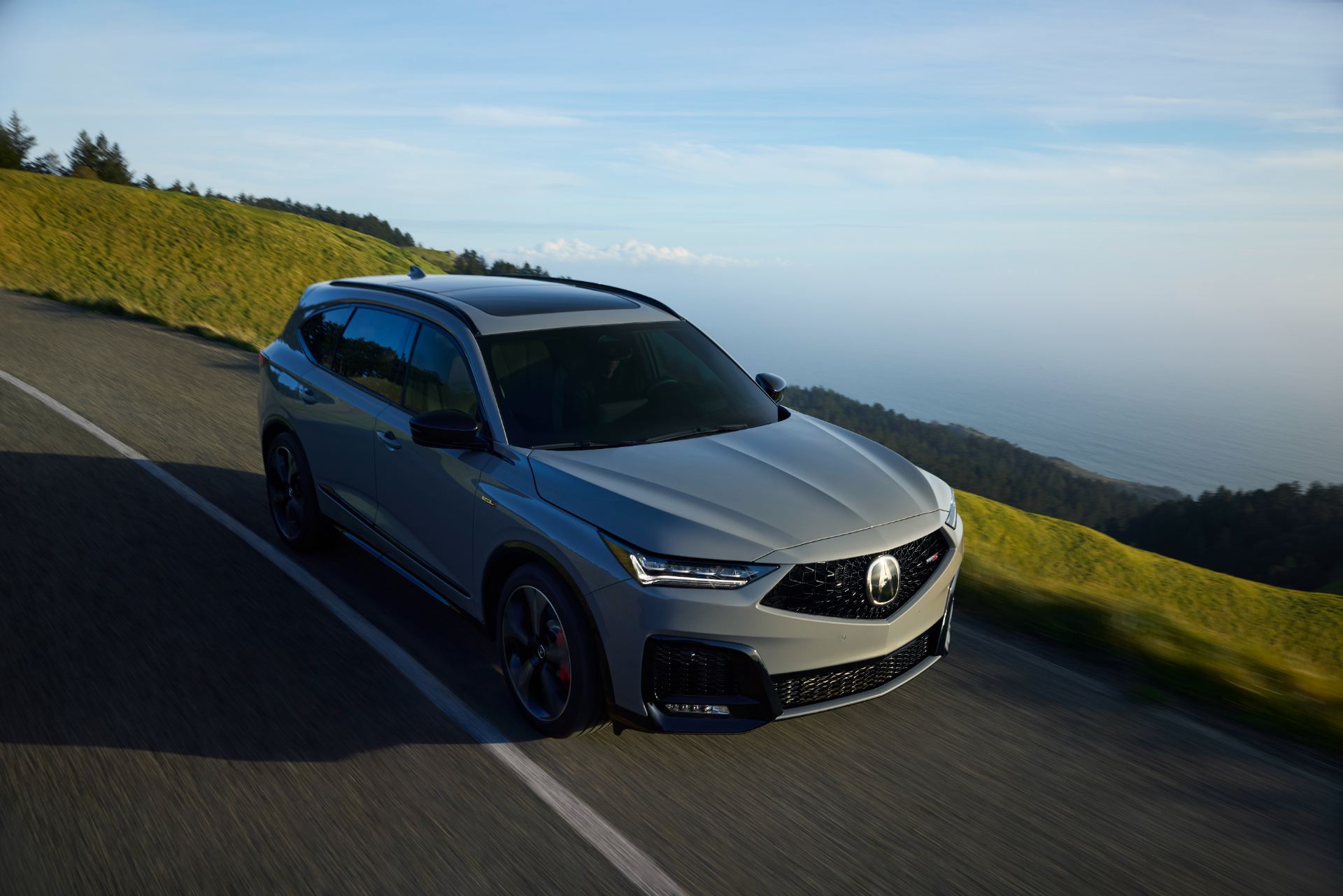 2025 acura mdx type s driving front three quarter coastal road grey