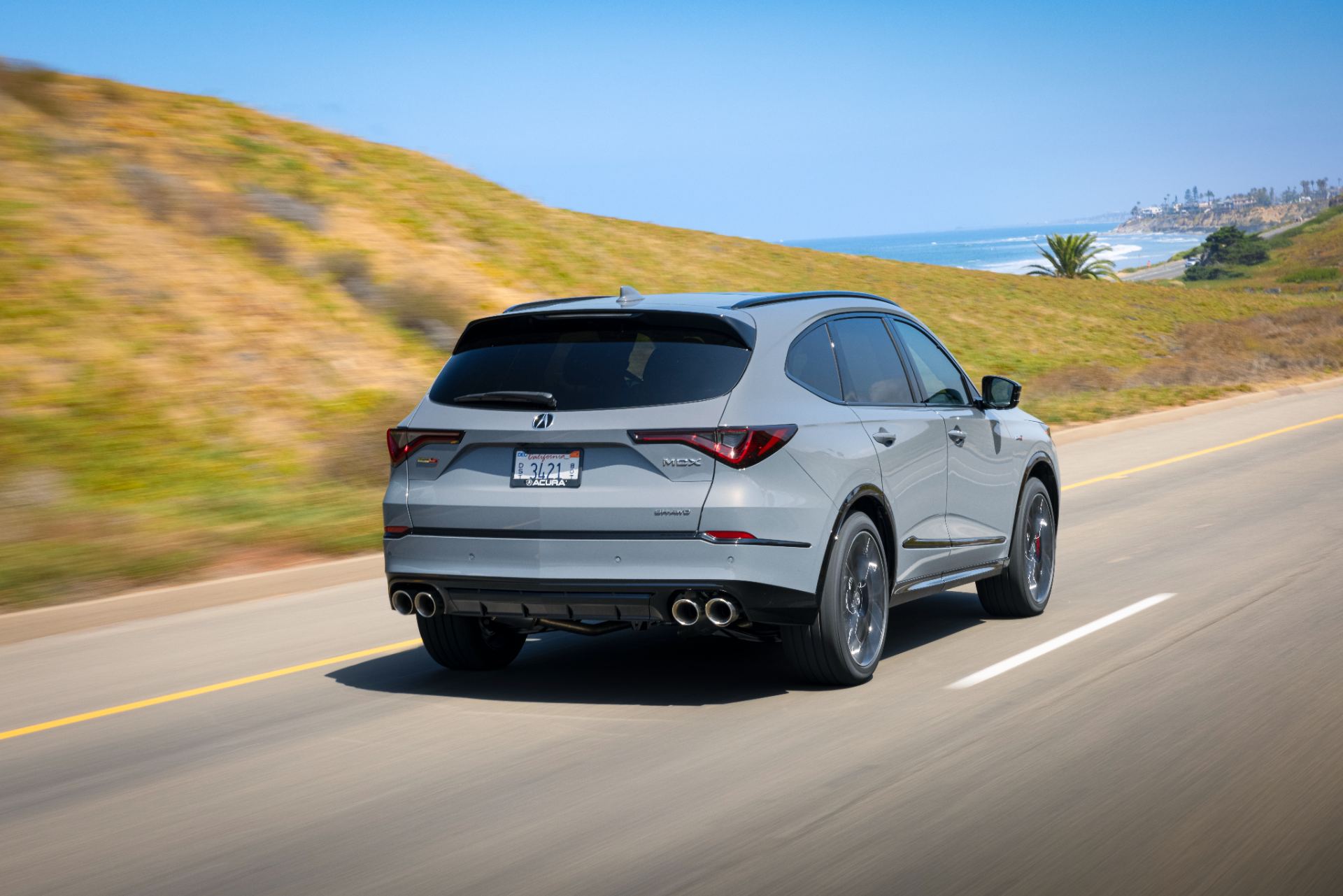 acura mdx type s driving rear three quarter coastal road grey