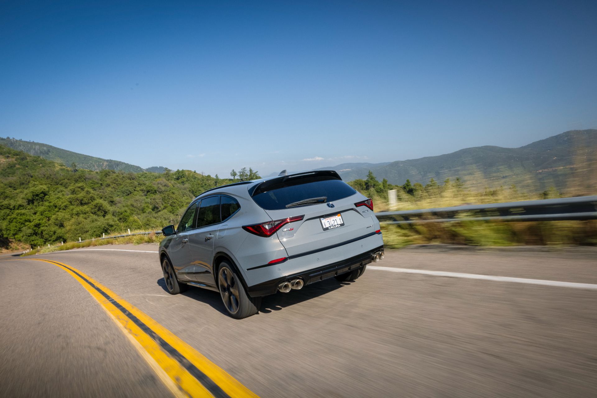 acura mdx type s driving rear three quarter mountain road grey