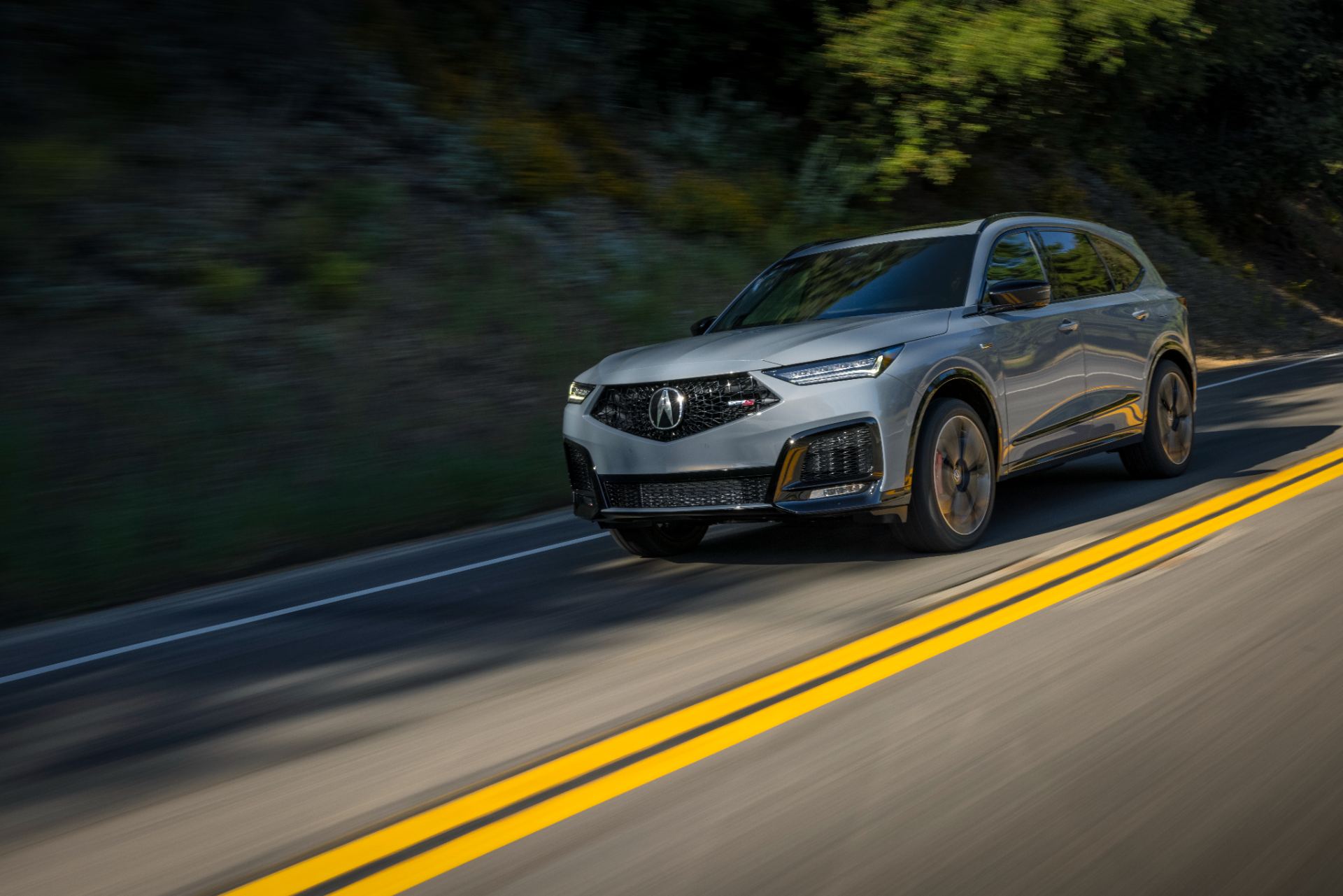 acura mdx type s driving front three quarter wooded road grey