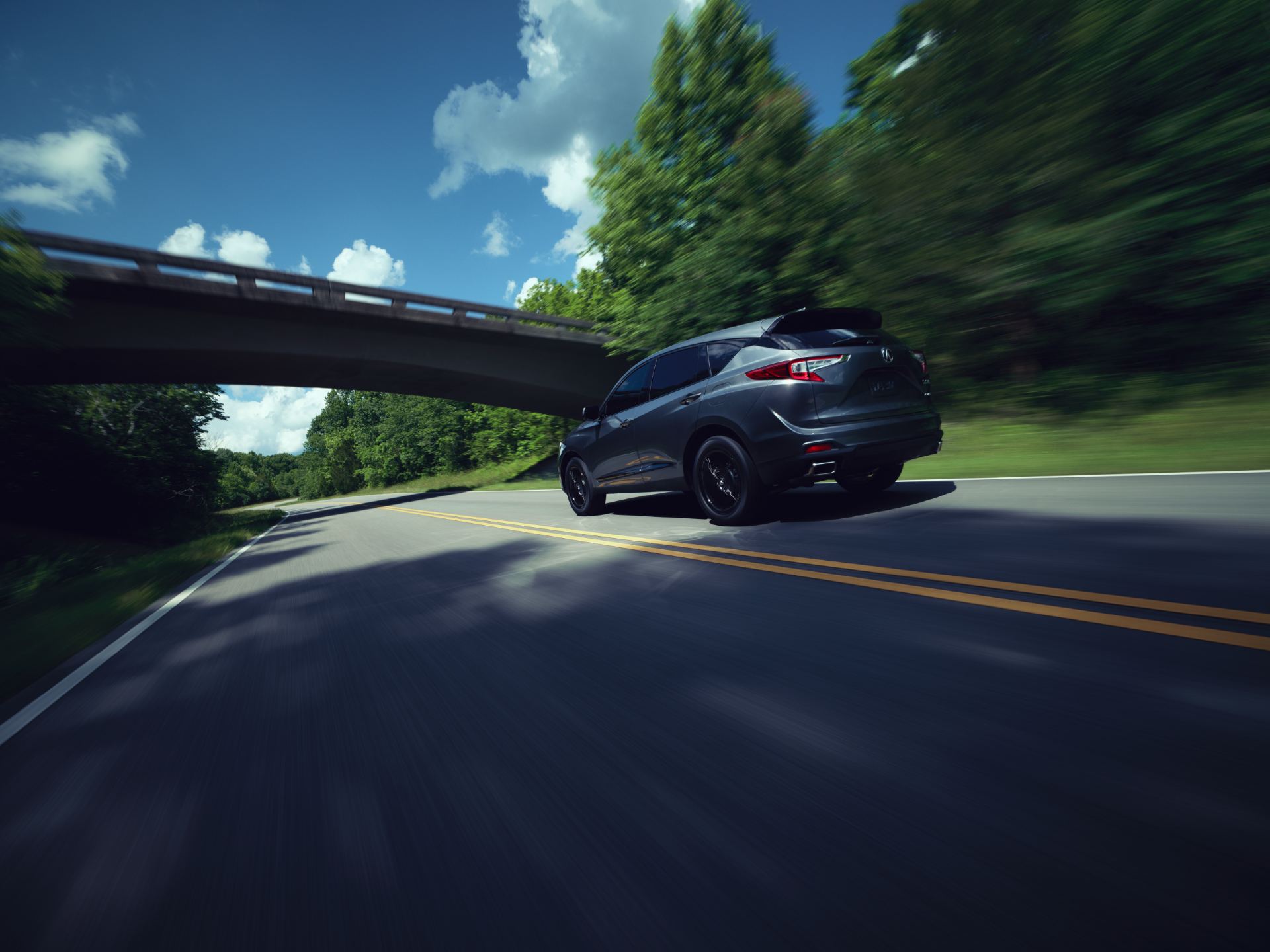 2025 acura rdx driving rear three quarter grey