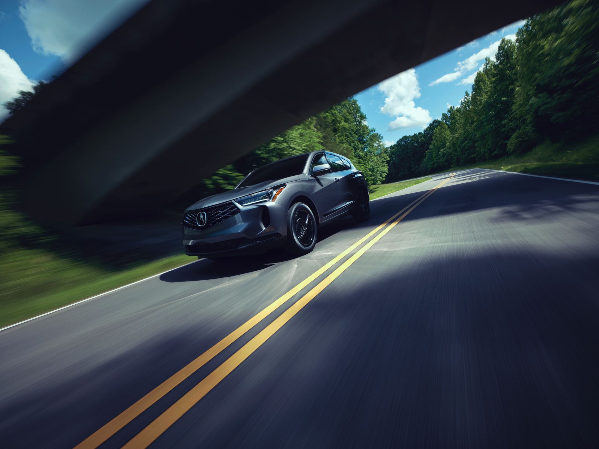 2025 acura rdx driving front three quarter grey