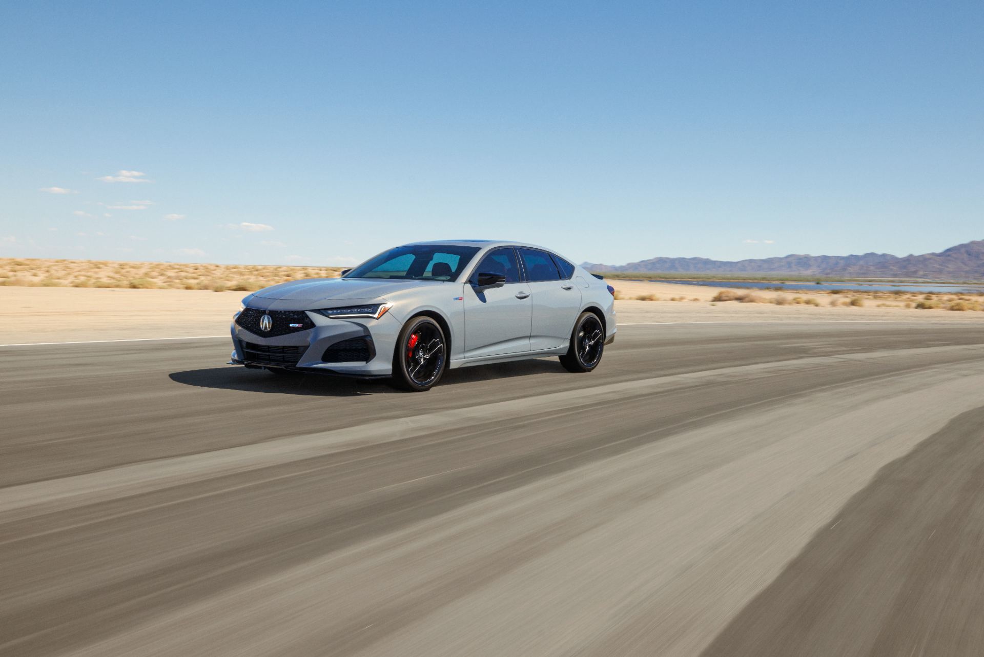 2024 acura tlx type s driving front three quarter grey