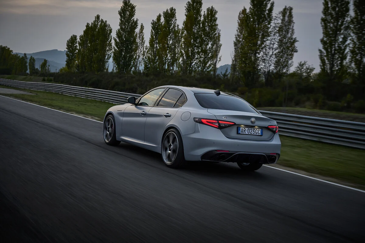 2026 alfa romeo giulia driving rear three quarter track grey