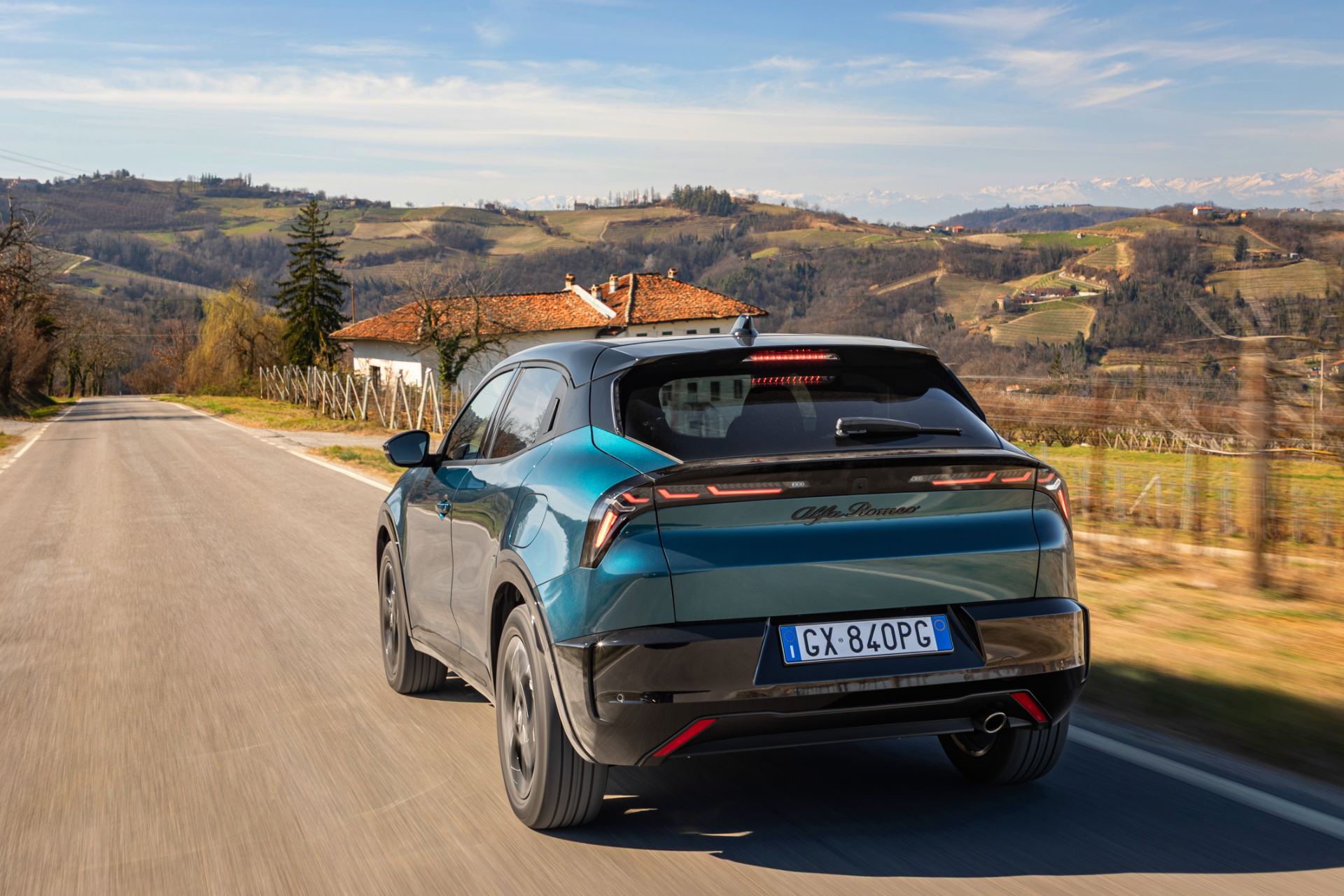 2026 alfa romeo junior ibrida q4 driving rear teal