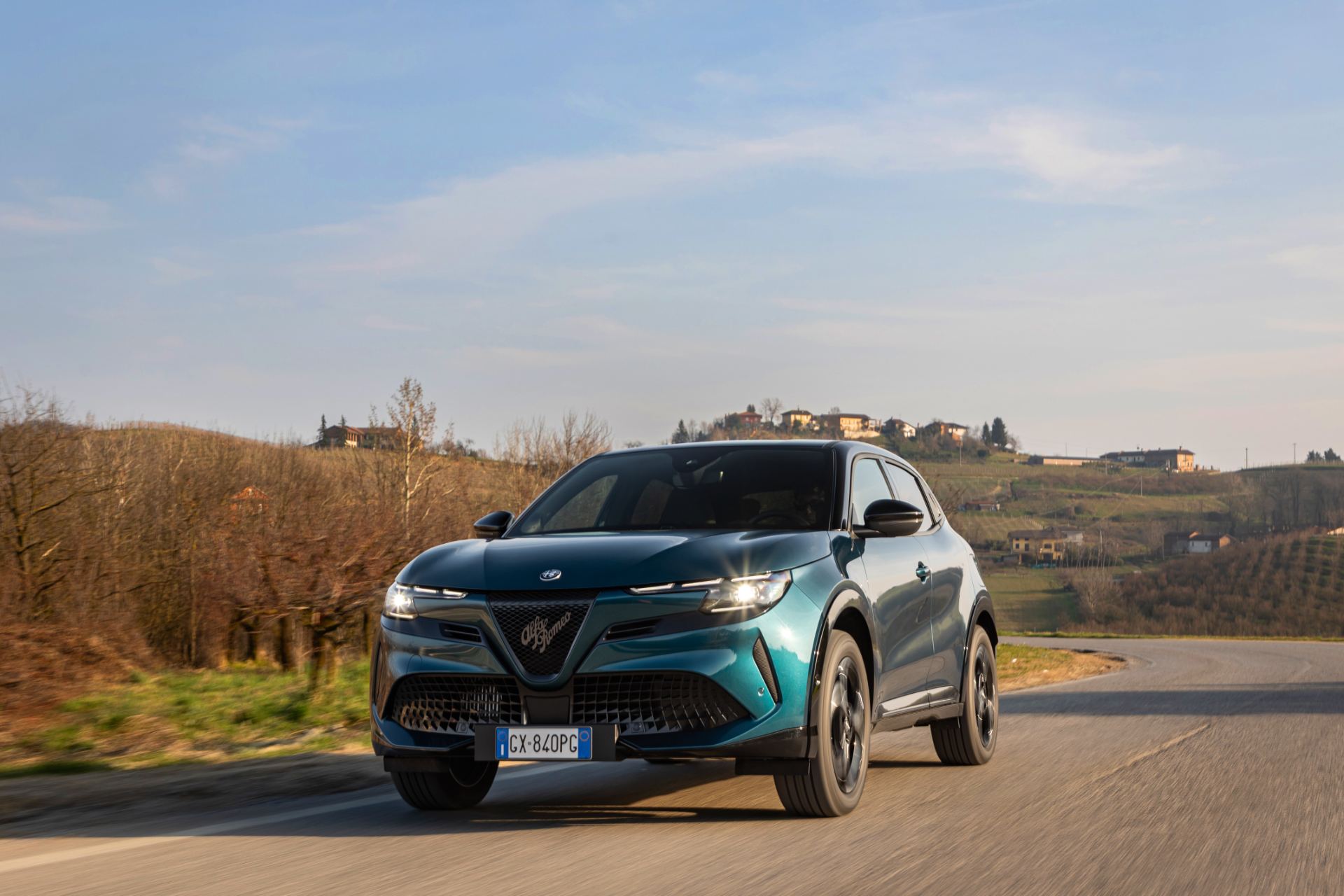 2026 alfa romeo junior ibrida q4 driving front three quarter teal
