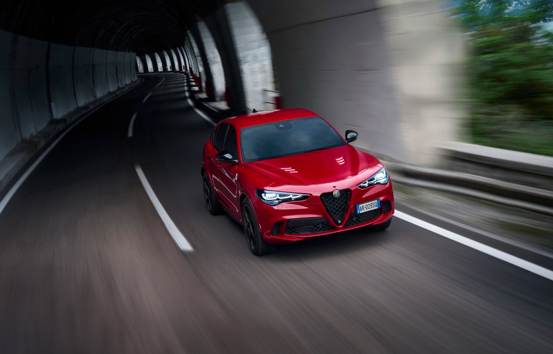 2026 alfa romeo stelvio quadrifoglio driving front three quarter tunnel red