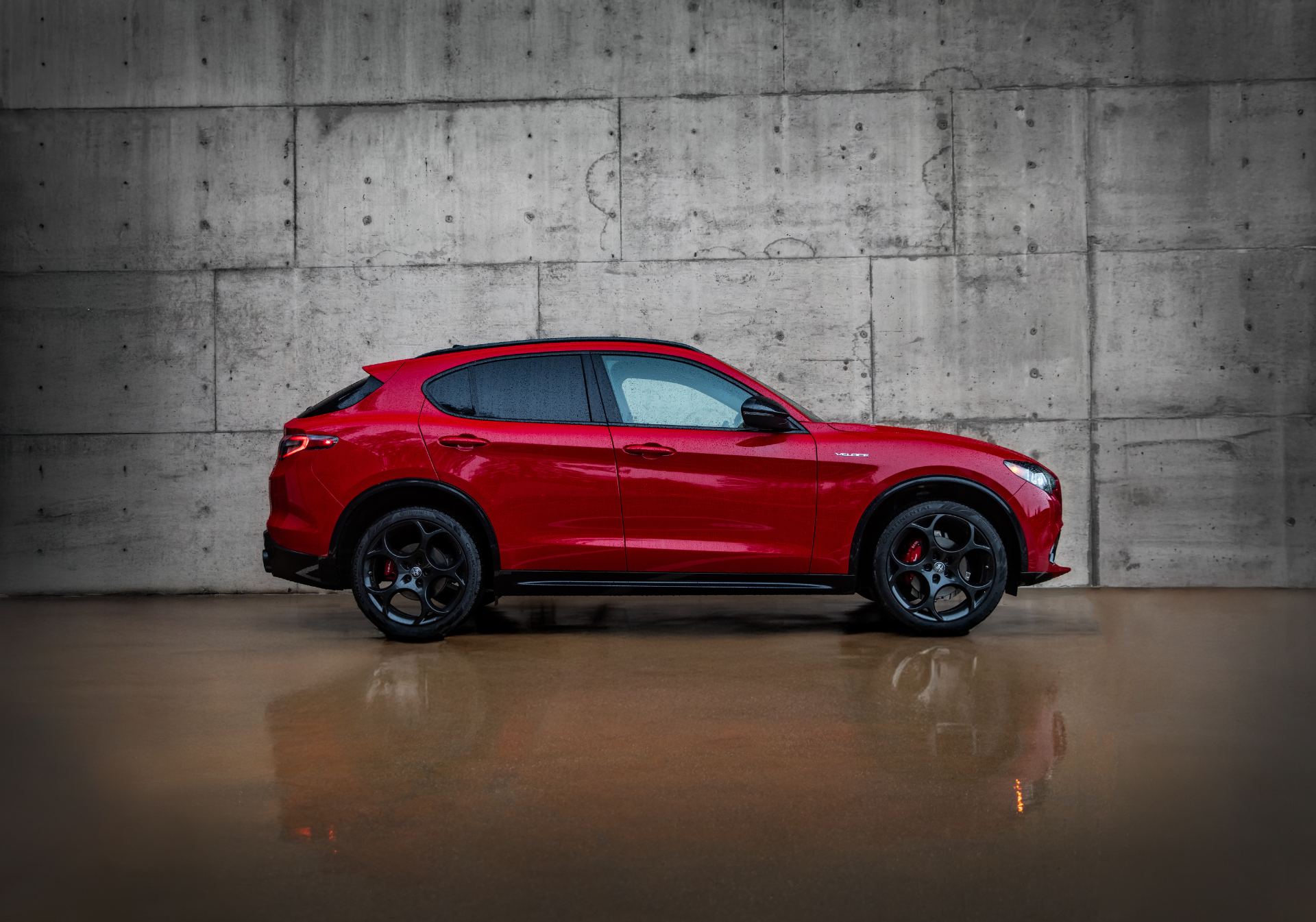 2026 alfa romeo stelvio side profile concrete wall red