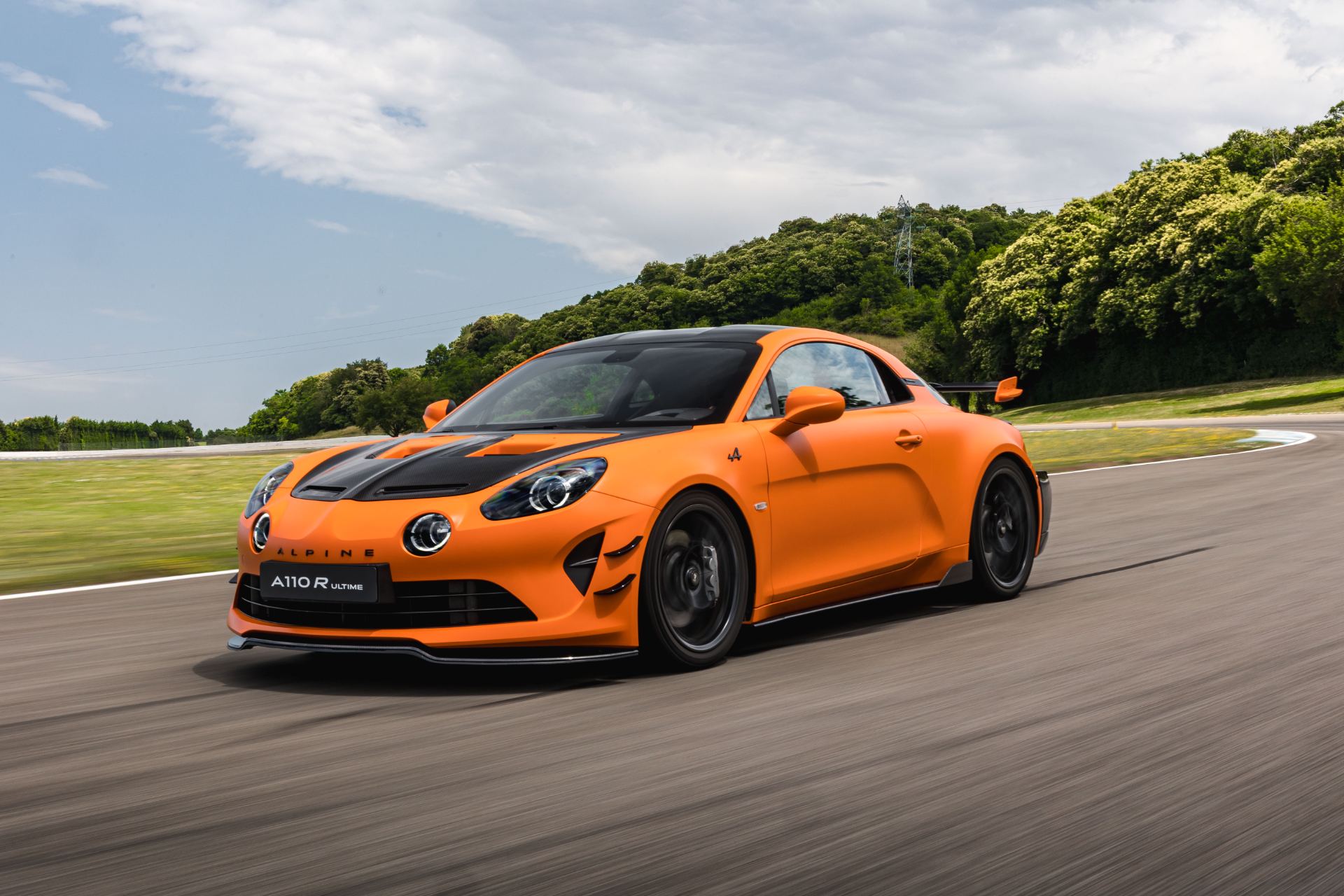 2026 alpine a110 r ultime driving front three quarter corner orange