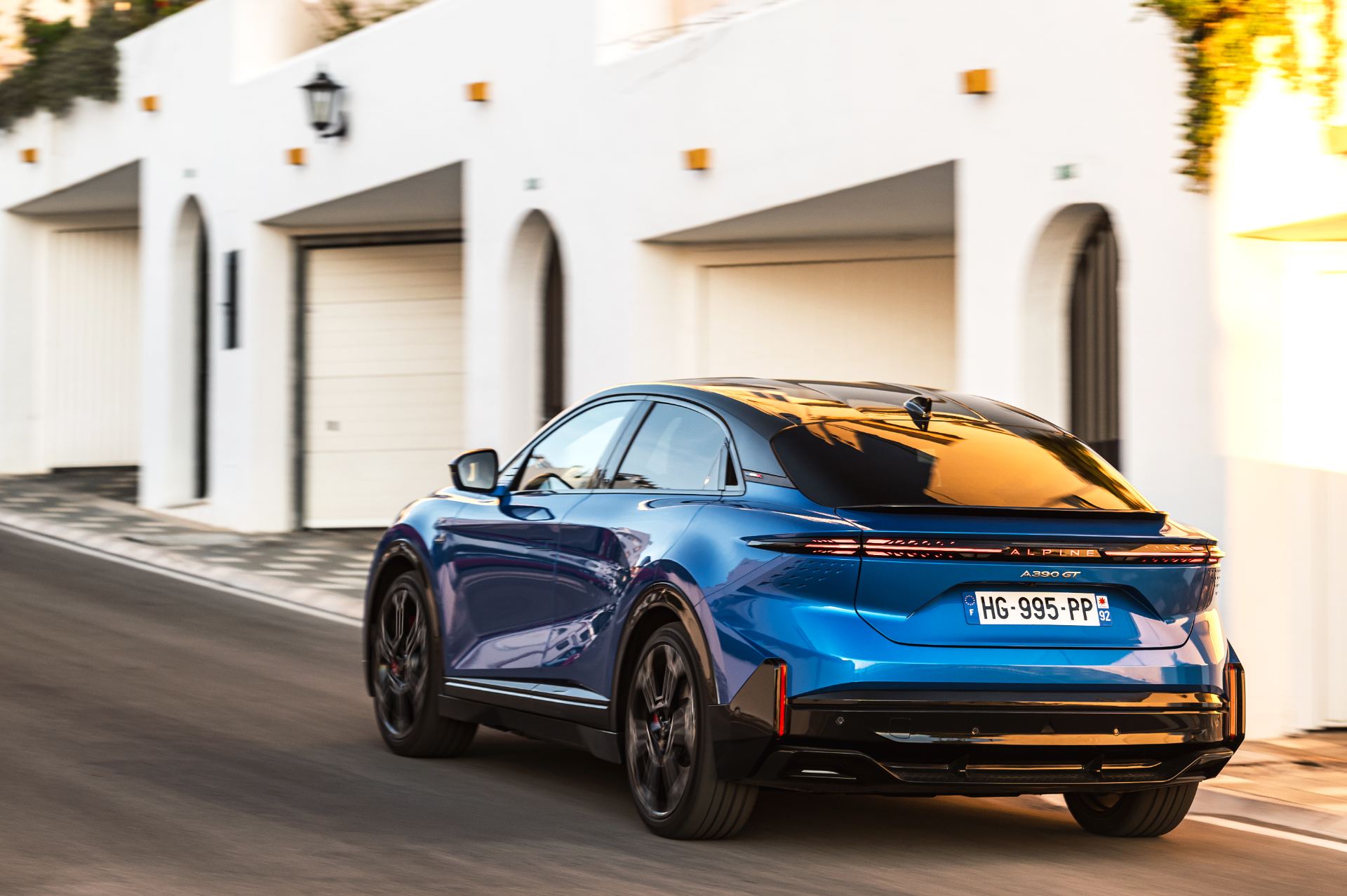 2026 alpine a390 gt driving rear three quarter alpine vision blue