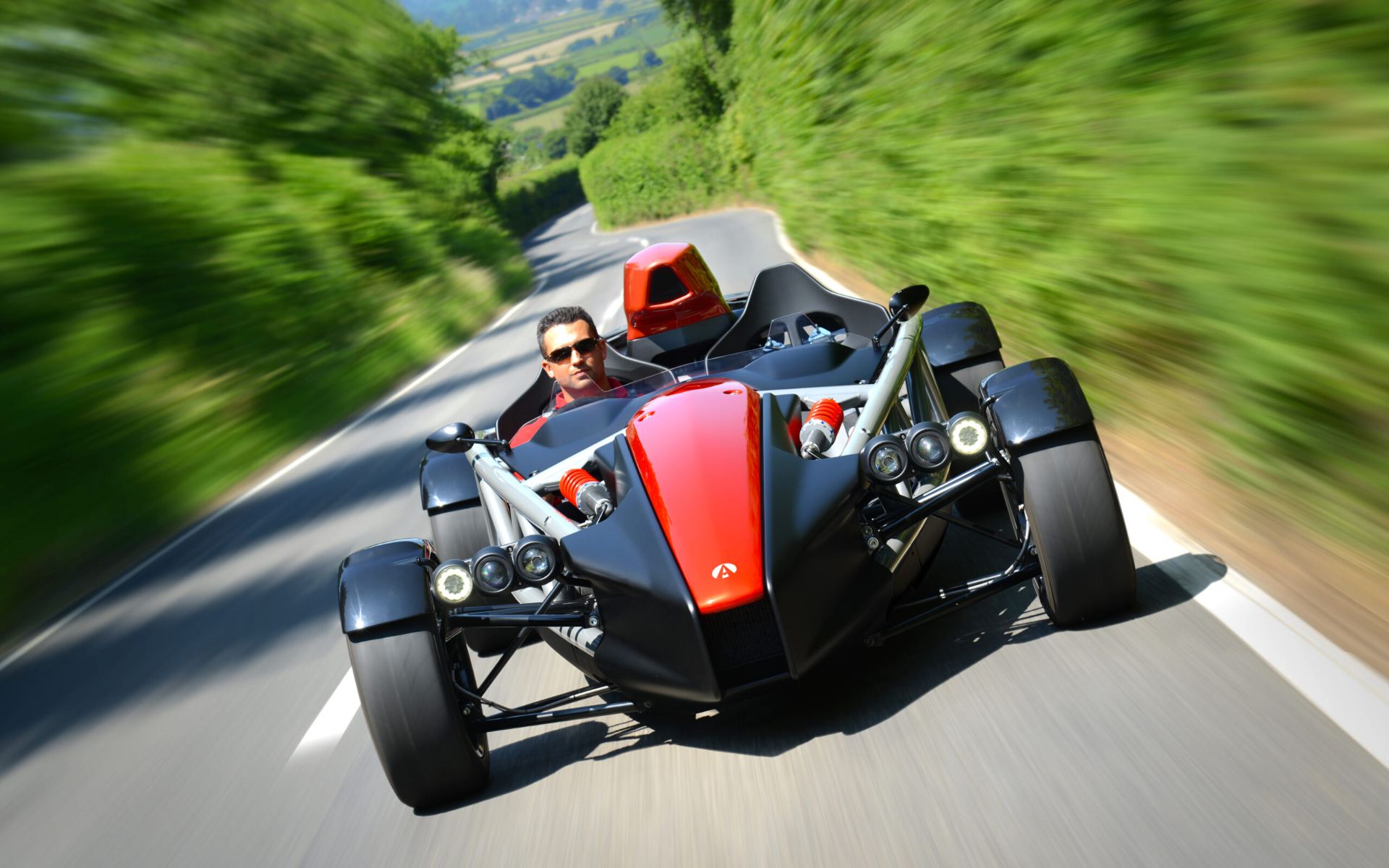 2026 ariel atom 4 driving front country lane orange