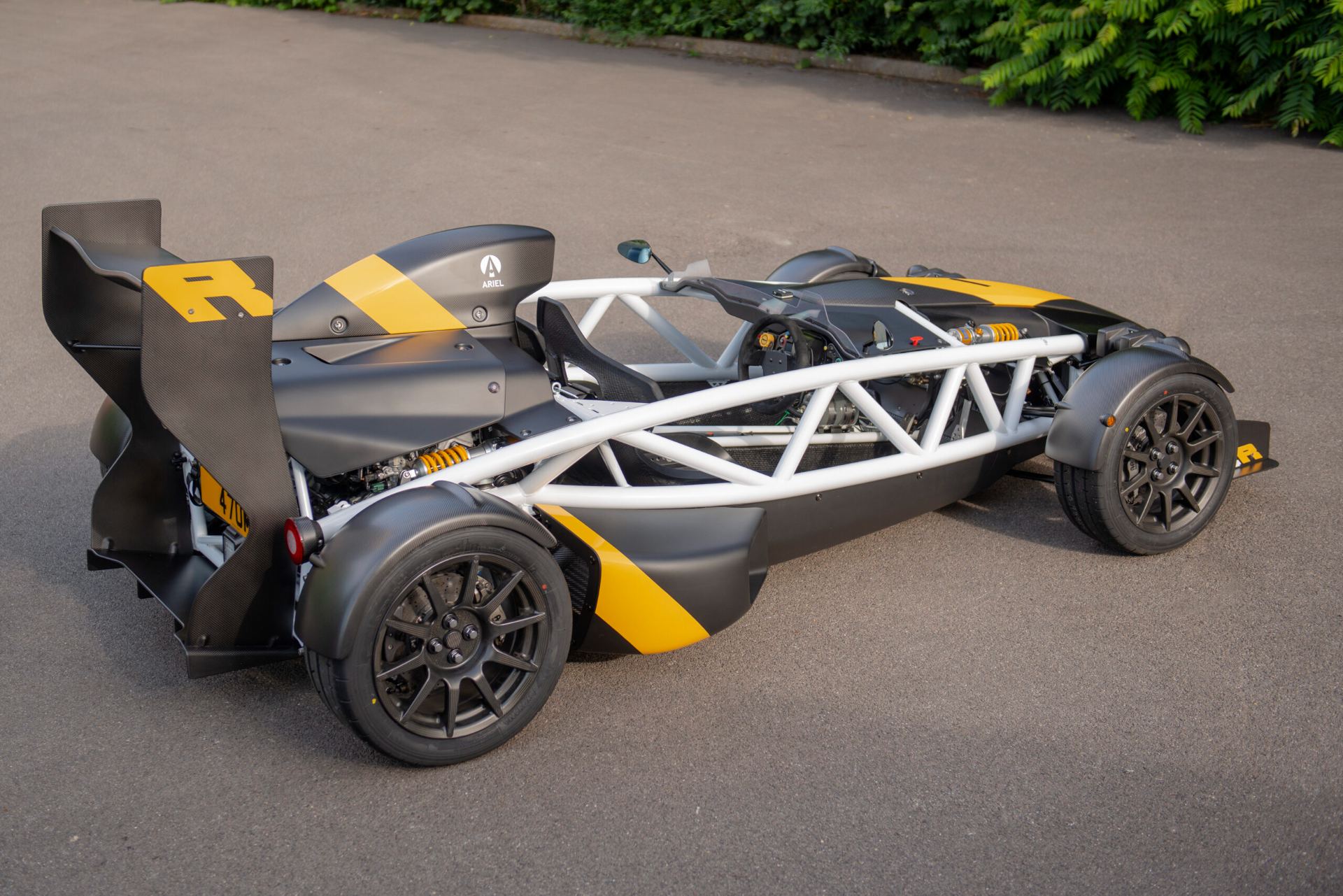 ariel atom 4r rear three quarter high angle black and yellow
