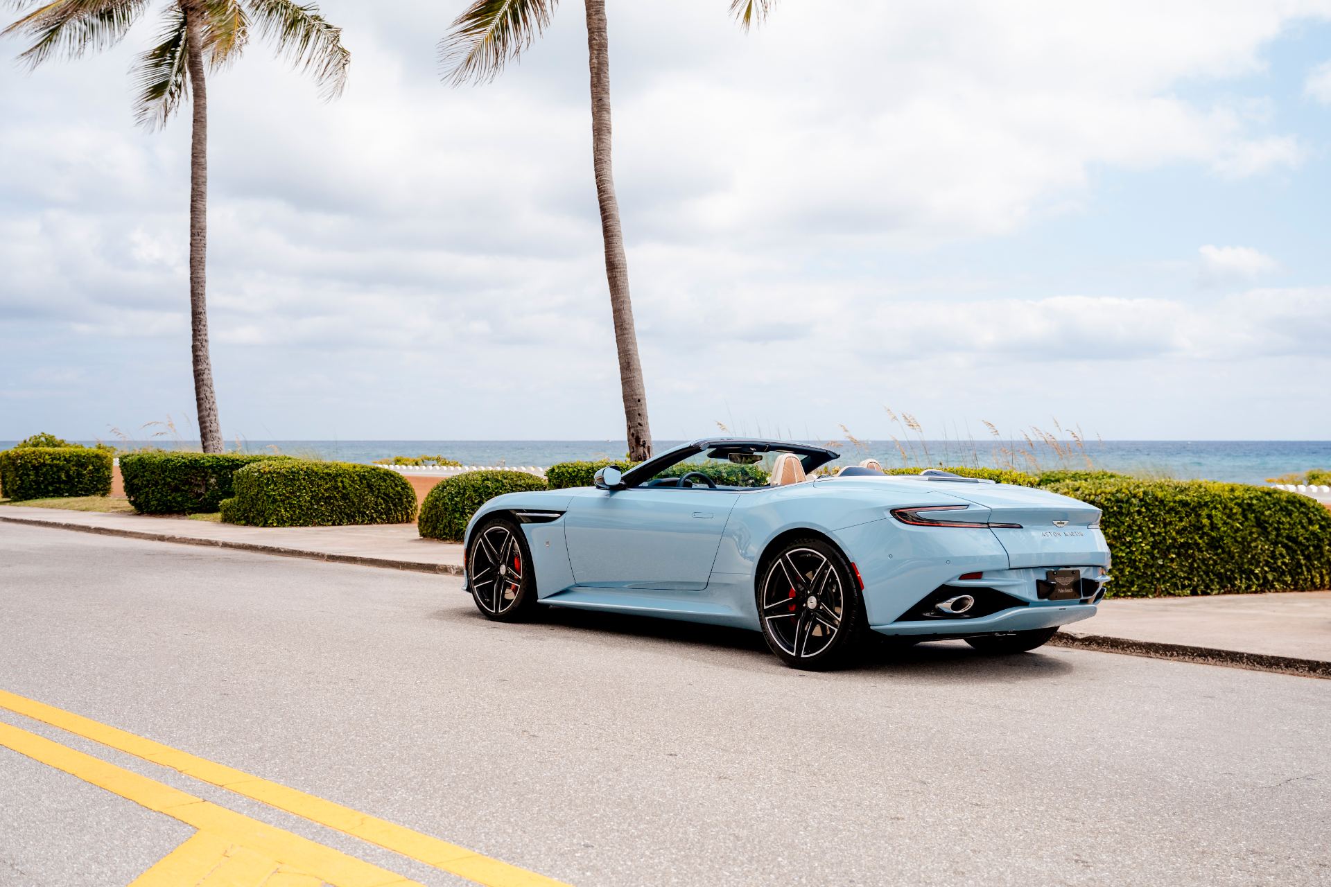 2026 aston martin db12 volante palm beach edition rear three quarter light blue