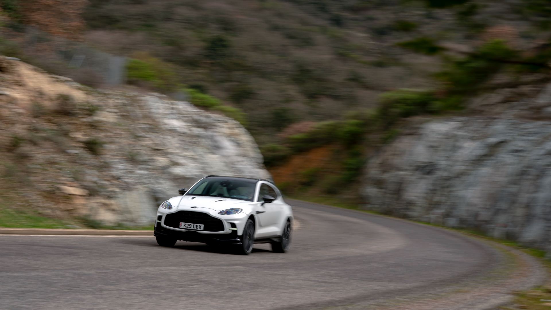 2026 aston martin dbx707 driving front mountain bend white