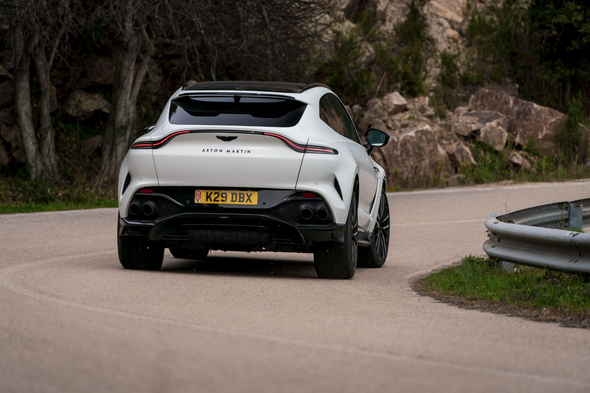 2026 aston martin dbx707 driving rear bend white