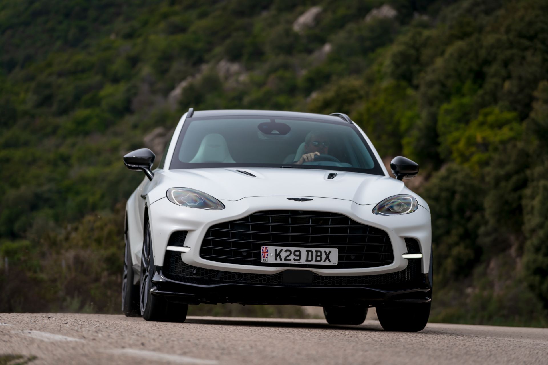 2026 aston martin dbx707 driving front hillside white
