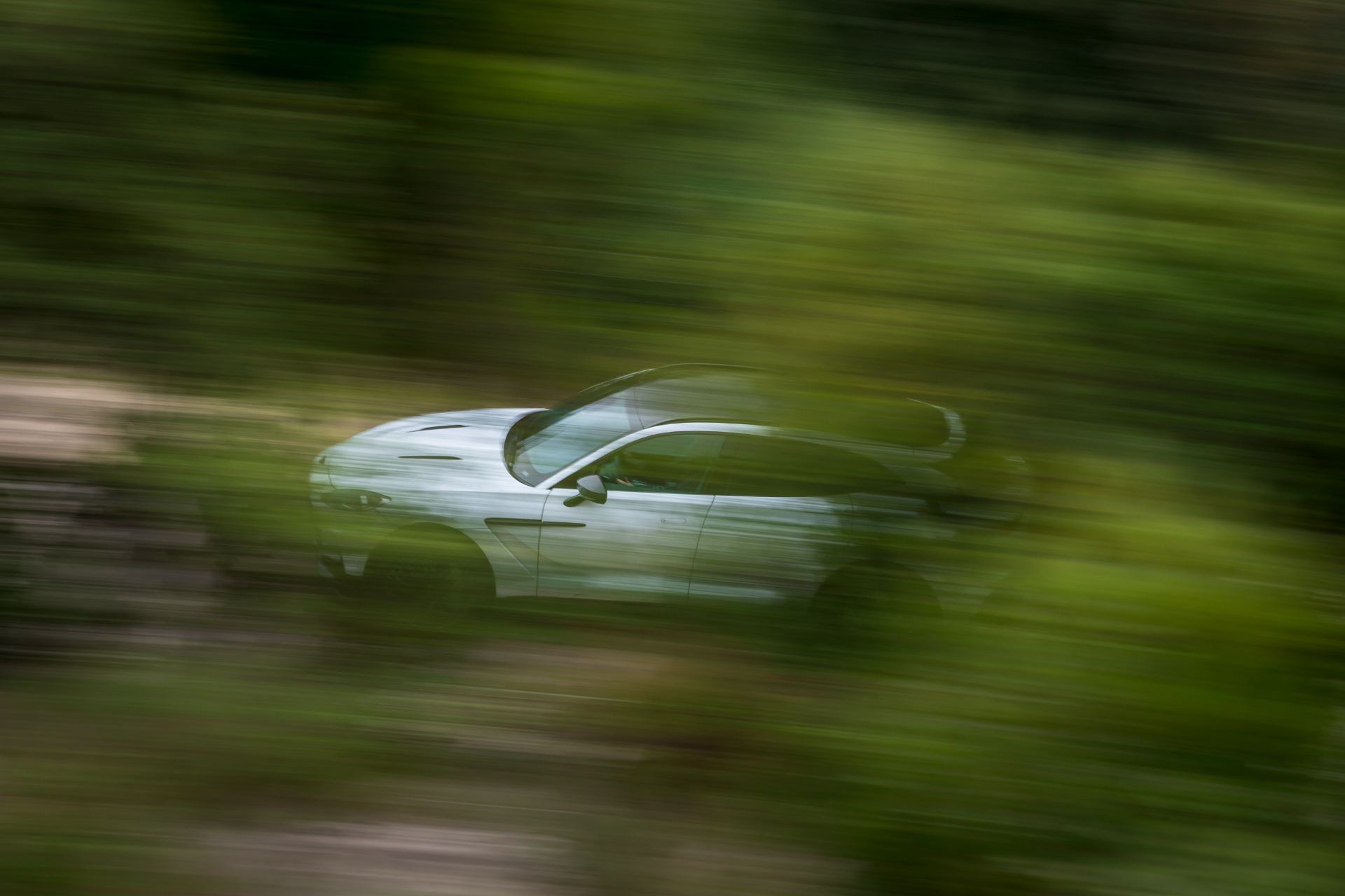 2026 aston martin dbx707 driving motion blur white