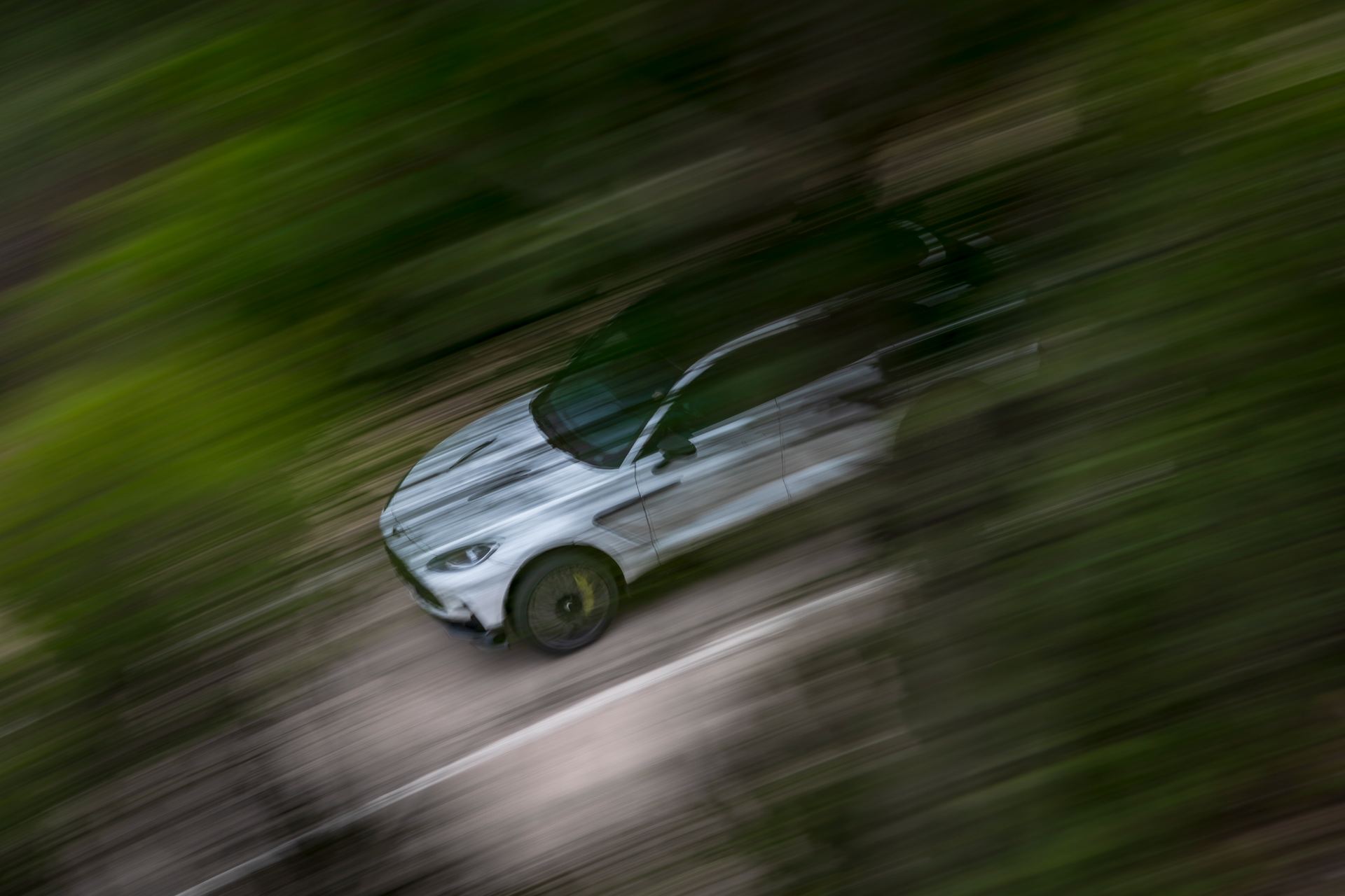 2026 aston martin dbx707 driving high speed blur white