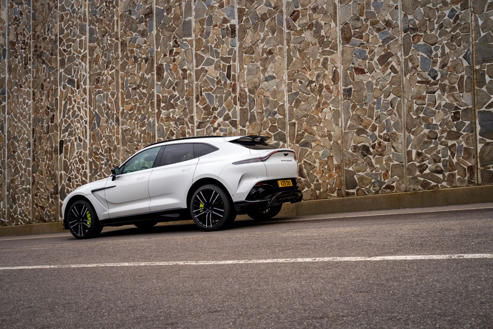 2026 aston martin dbx707 rear three quarter stone wall white