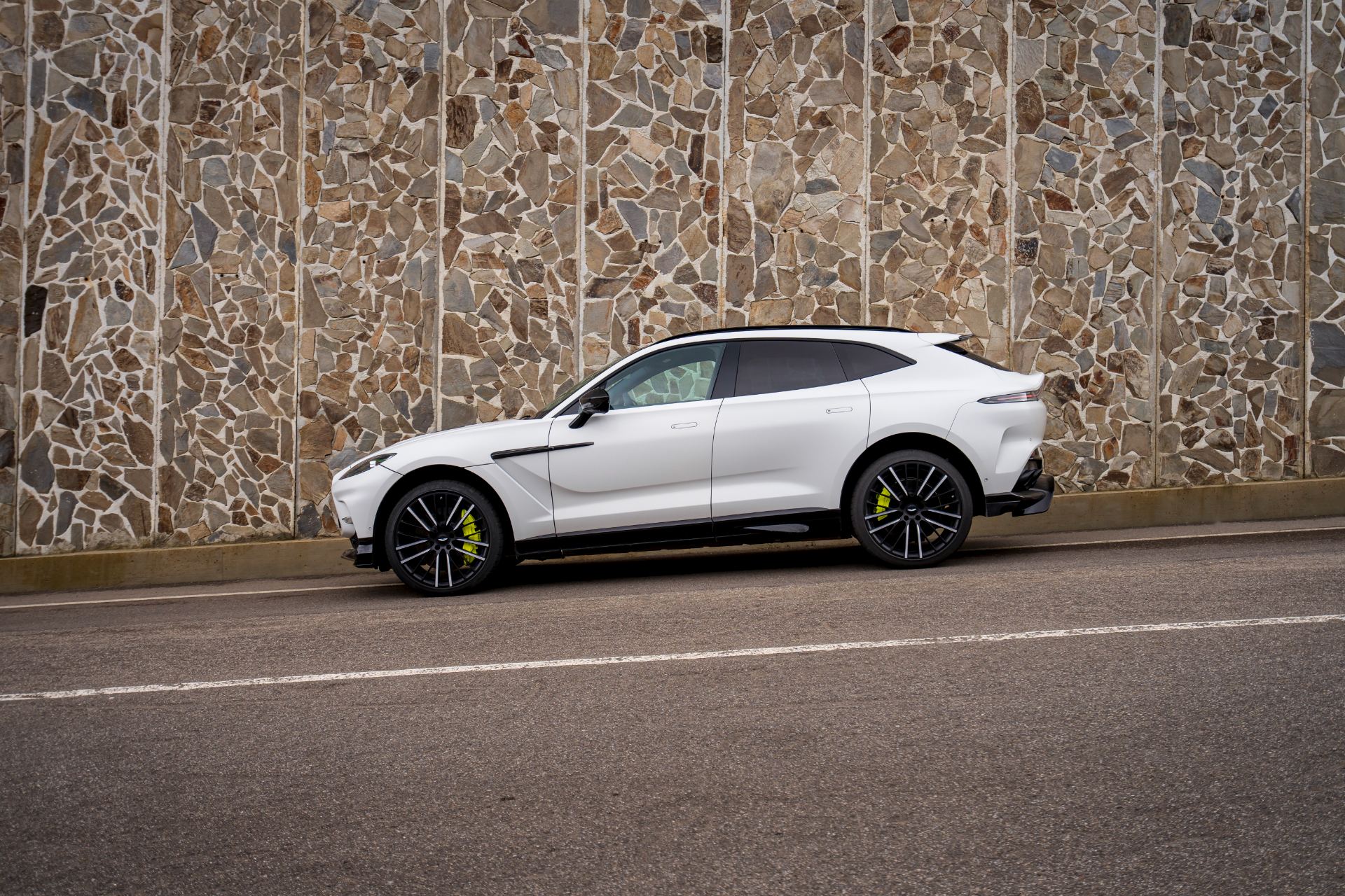 2026 aston martin dbx707 side profile stone wall white