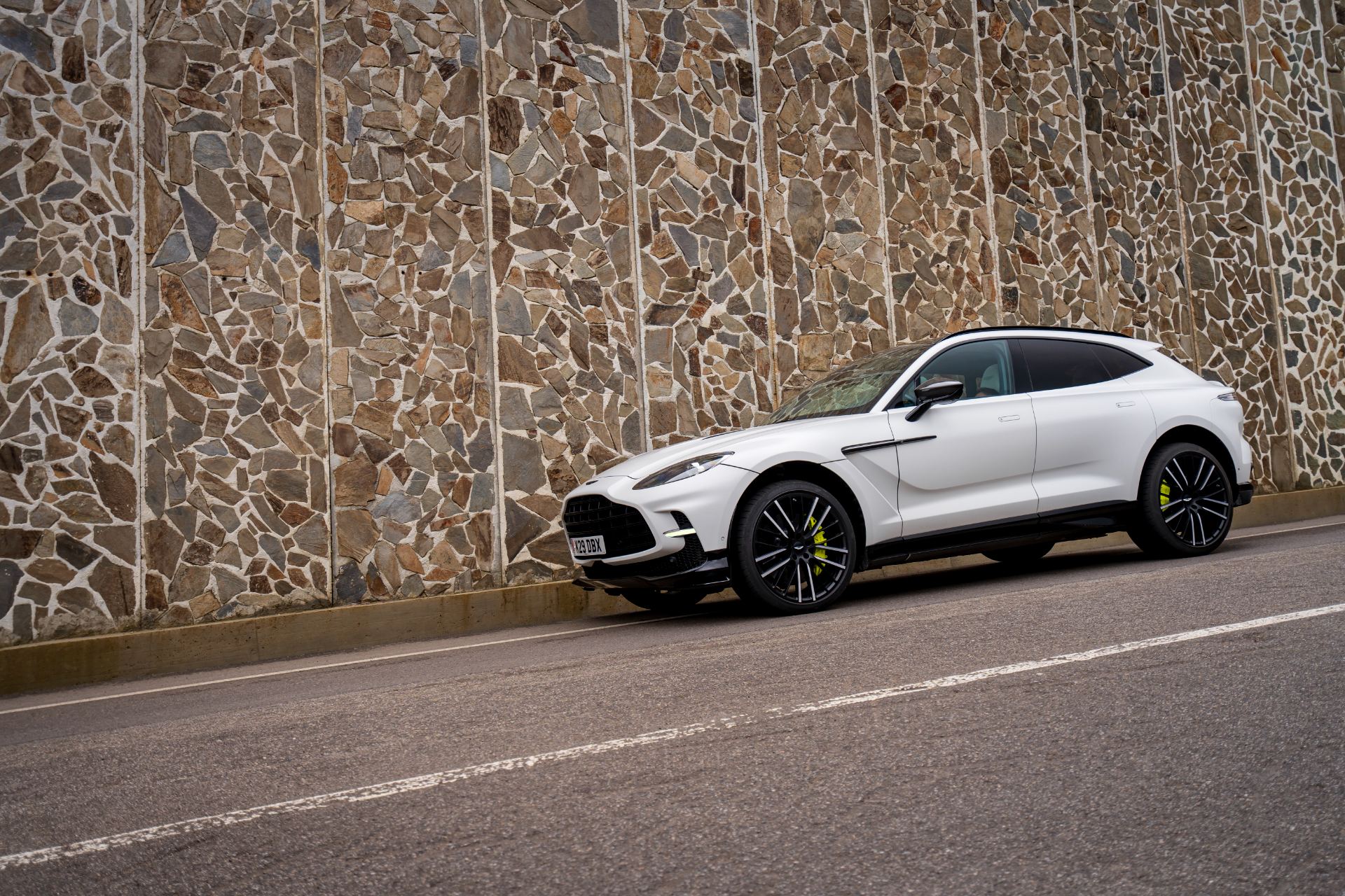 2026 aston martin dbx707 front three quarter stone wall white