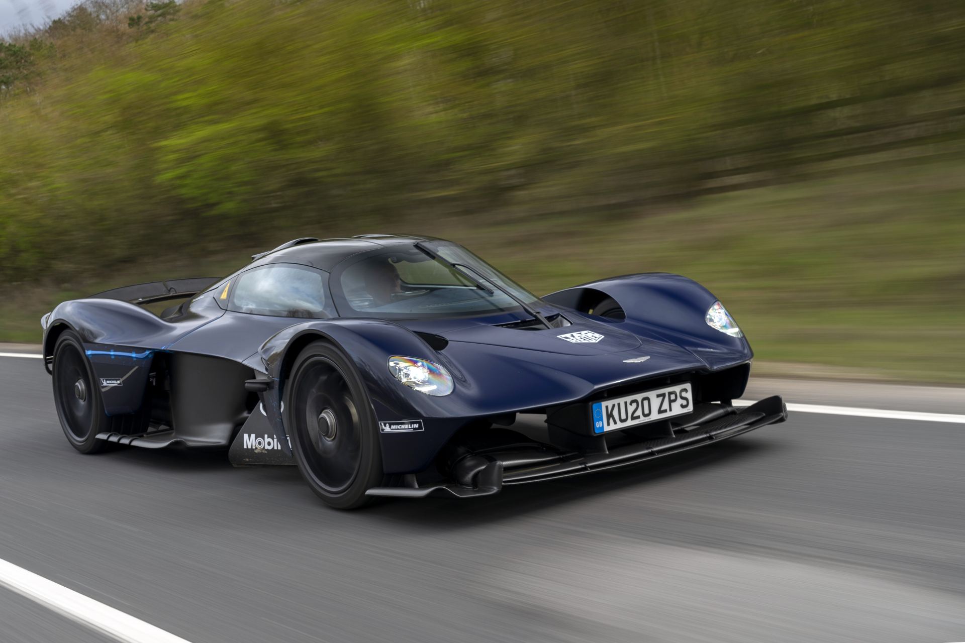 2026 aston martin valkyrie driving front three quarter dark blue