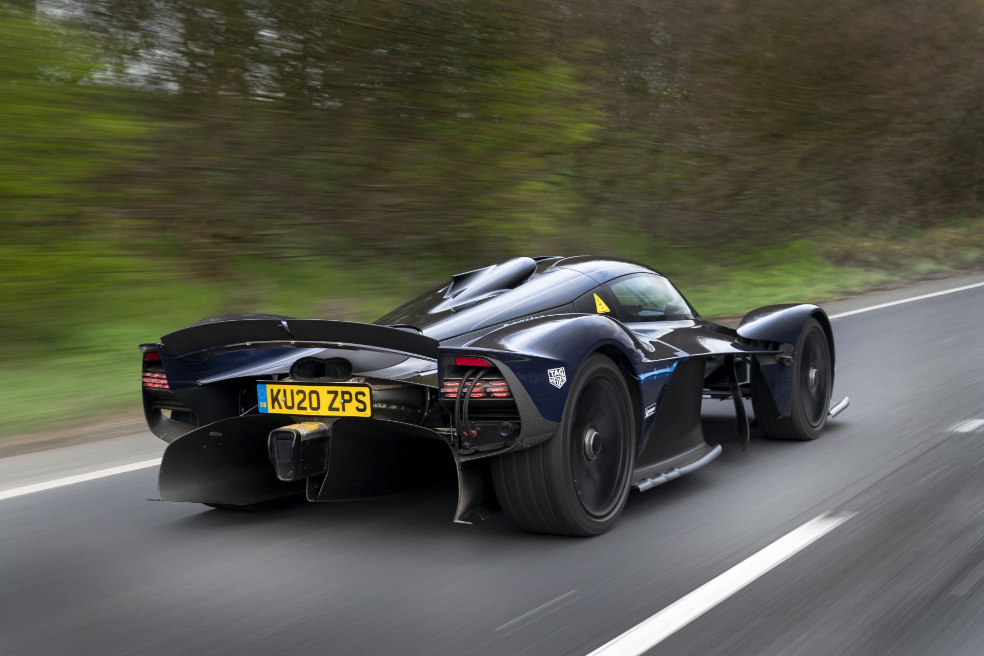 2026 aston martin valkyrie driving rear three quarter dark blue