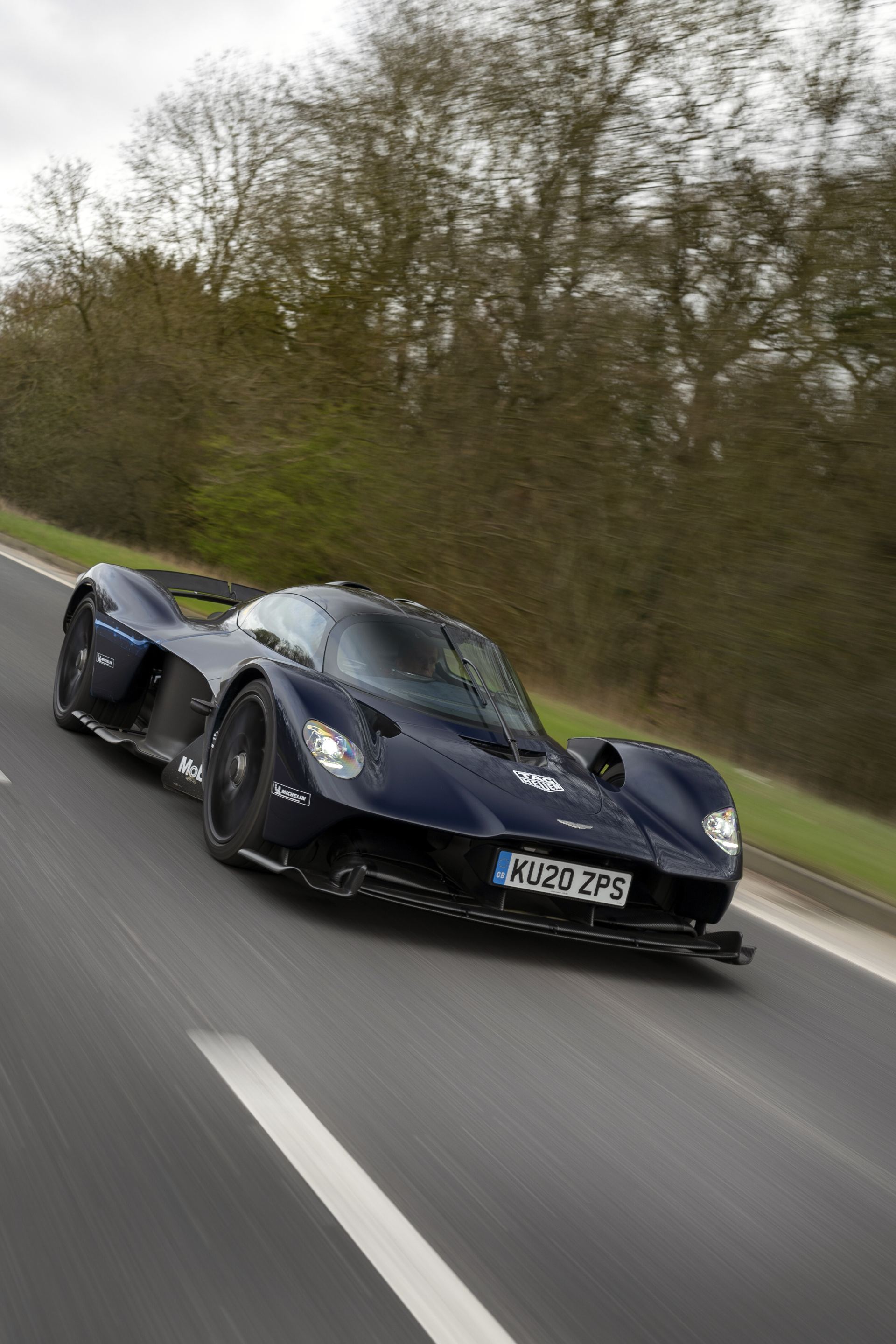2026 aston martin valkyrie driving front forest road dark blue