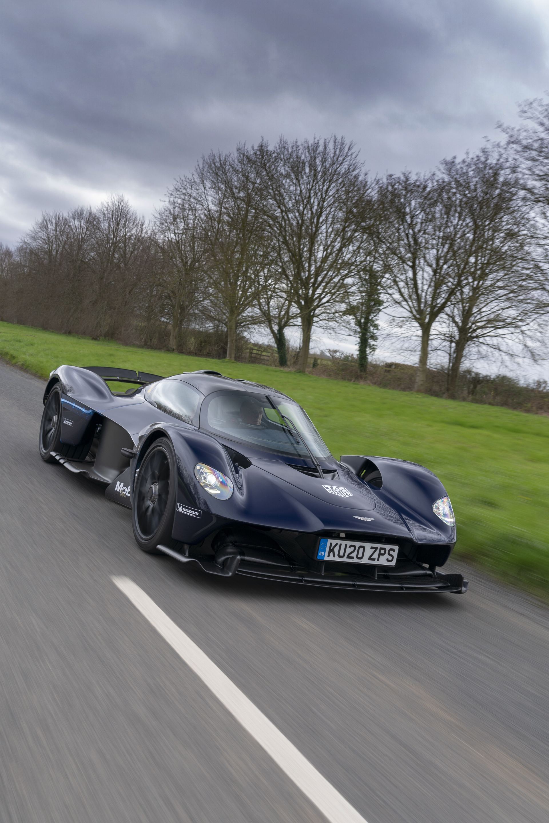 2026 aston martin valkyrie driving front open road dark blue