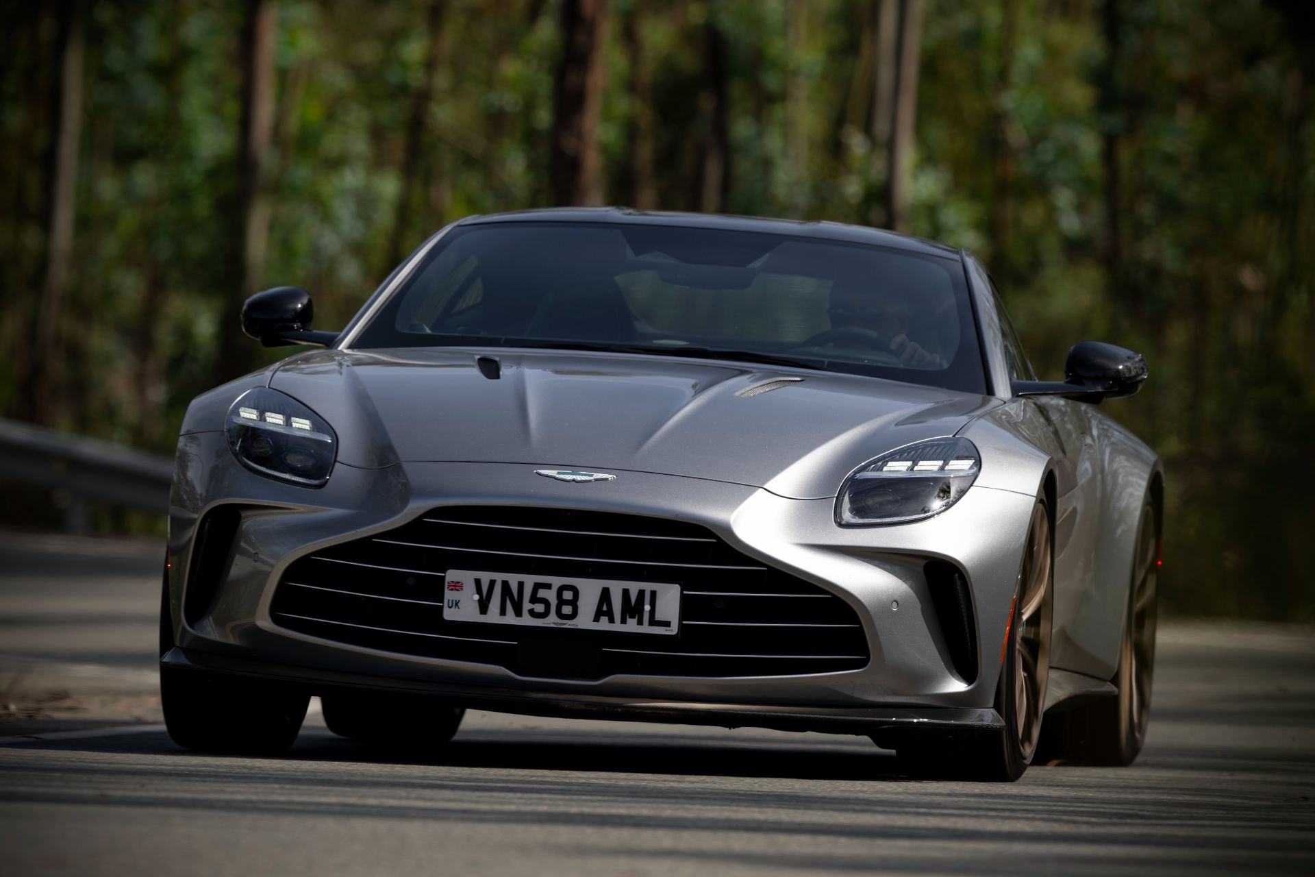2026 aston martin vantage driving front forest silver