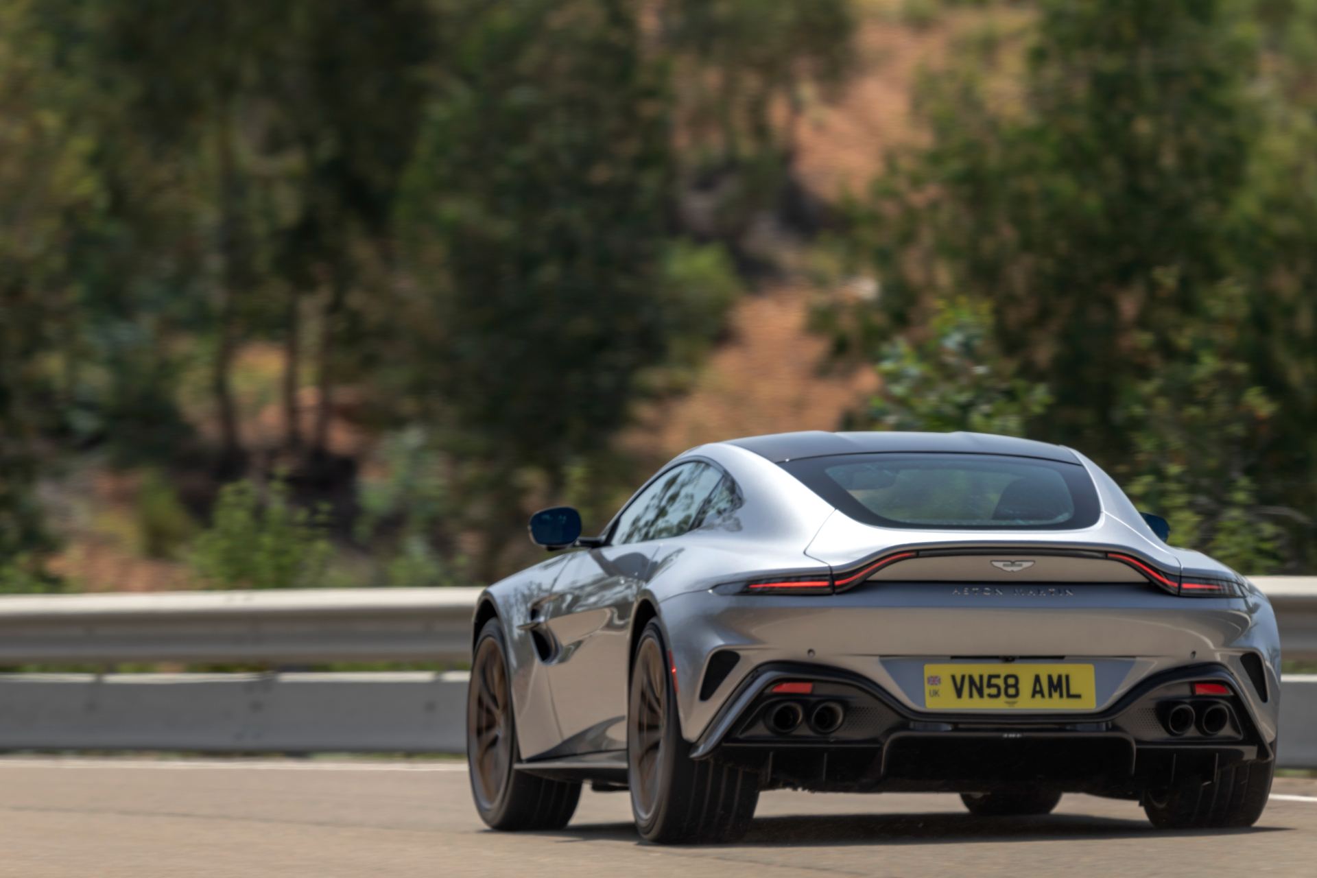 2026 aston martin vantage driving rear silver