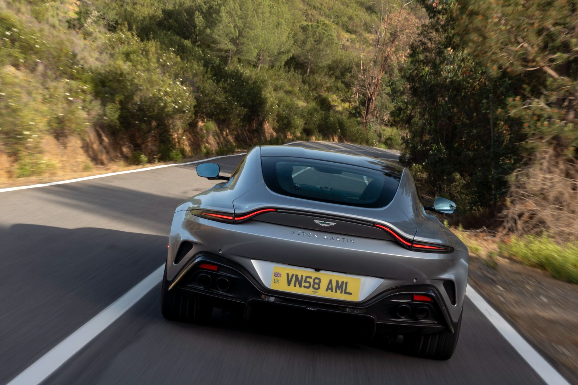 2026 aston martin vantage driving rear bend silver