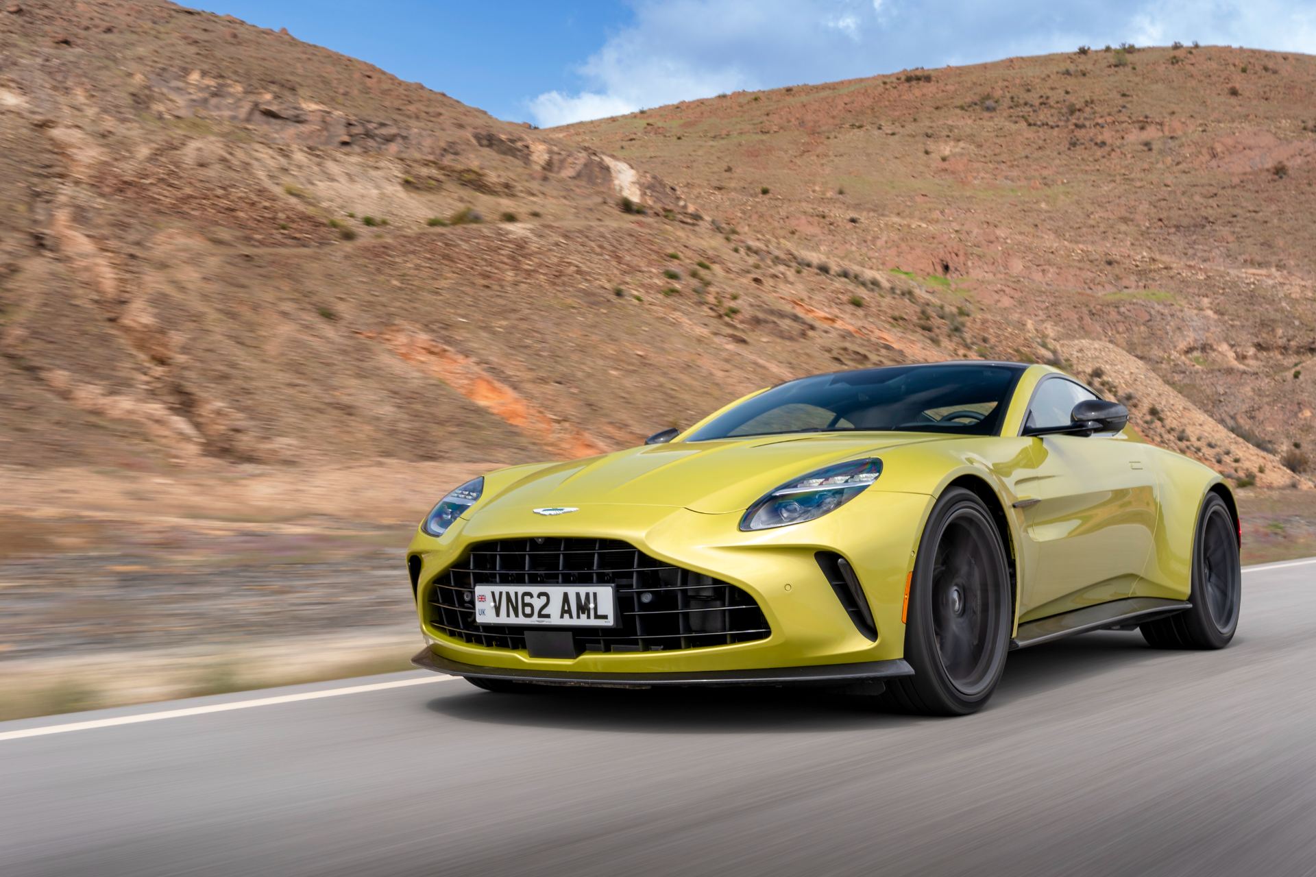 2026 aston martin vantage driving front three quarter yellow