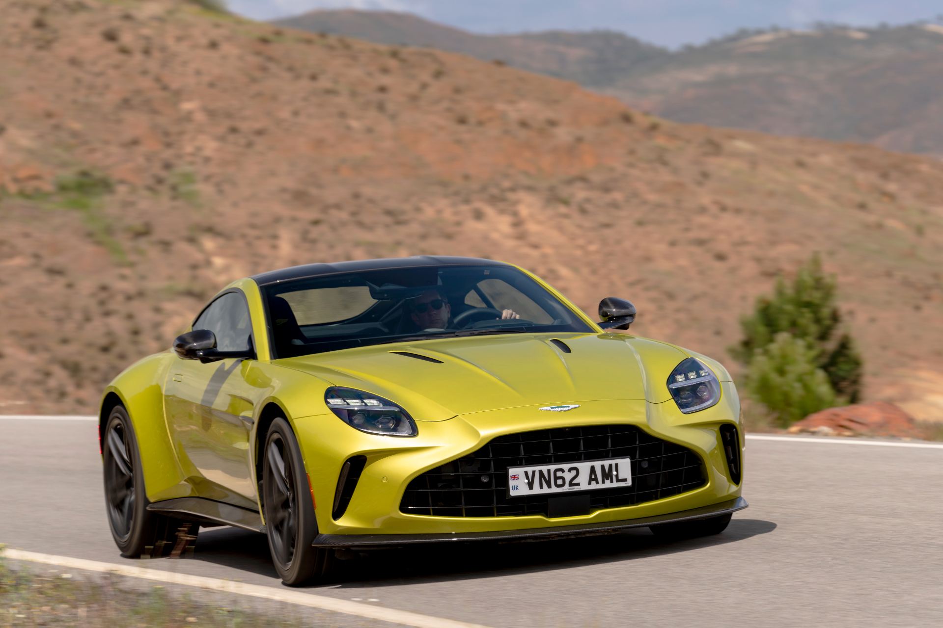 2026 aston martin vantage driving front hillside yellow