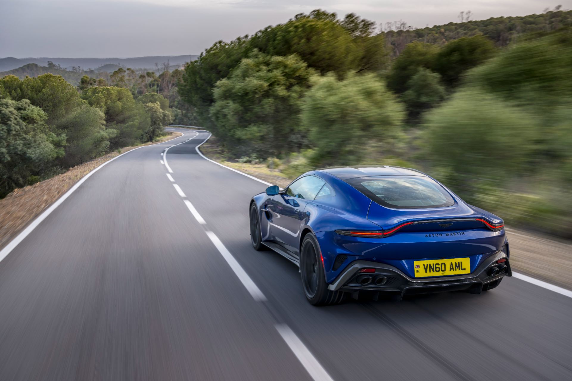 2026 aston martin vantage driving rear three quarter ion blue