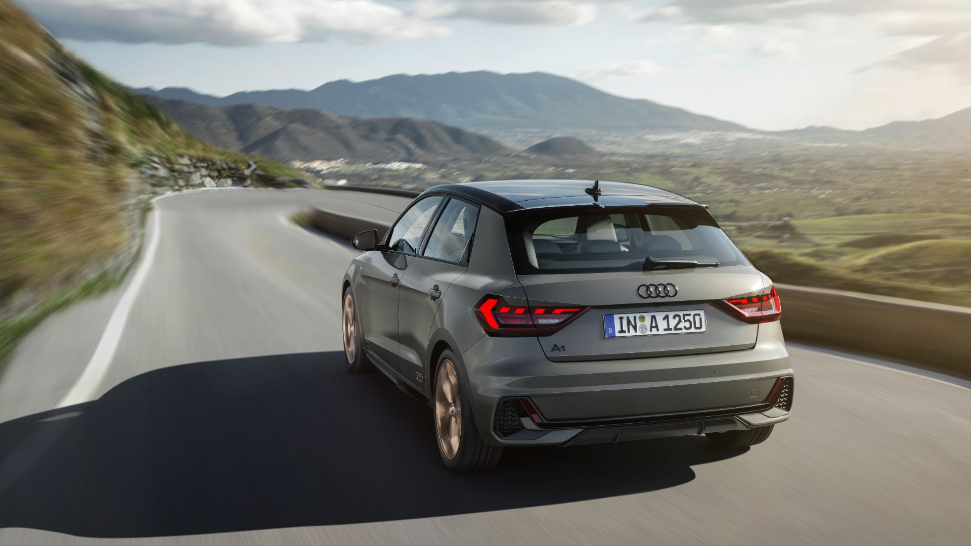 2026 audi a1 sportback driving rear three quarter mountain road grey